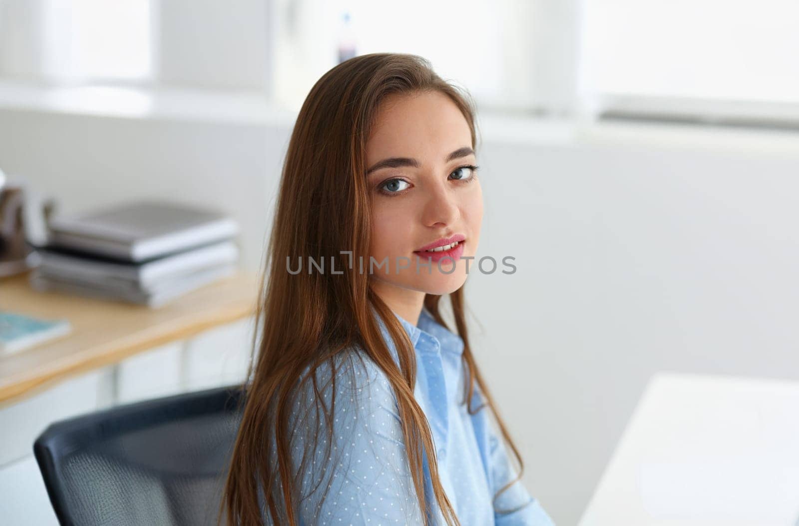 woman portrait on gray backgroung in blue shirt