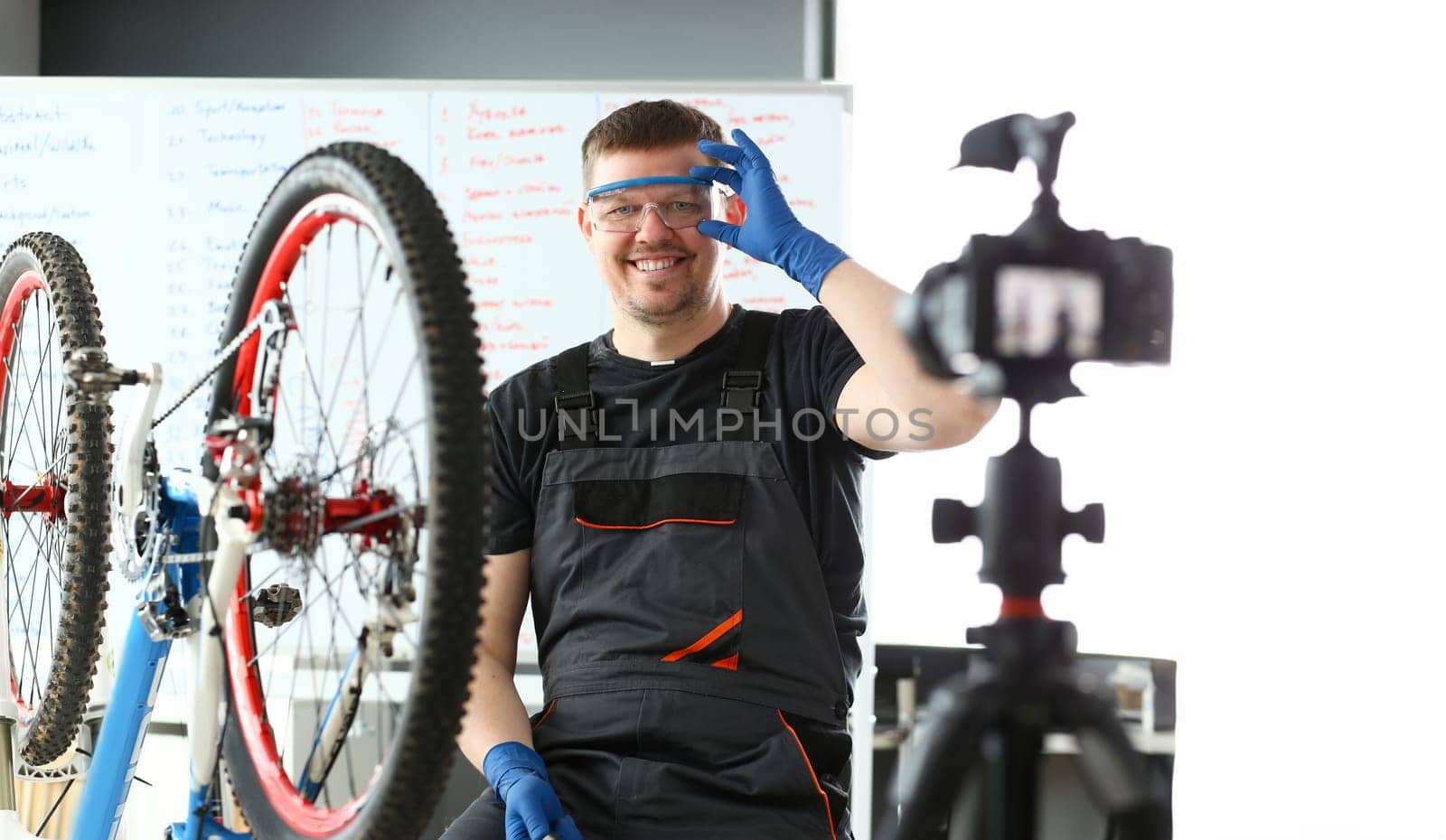 Handsome blogger service man bicycle workshop repair portrait