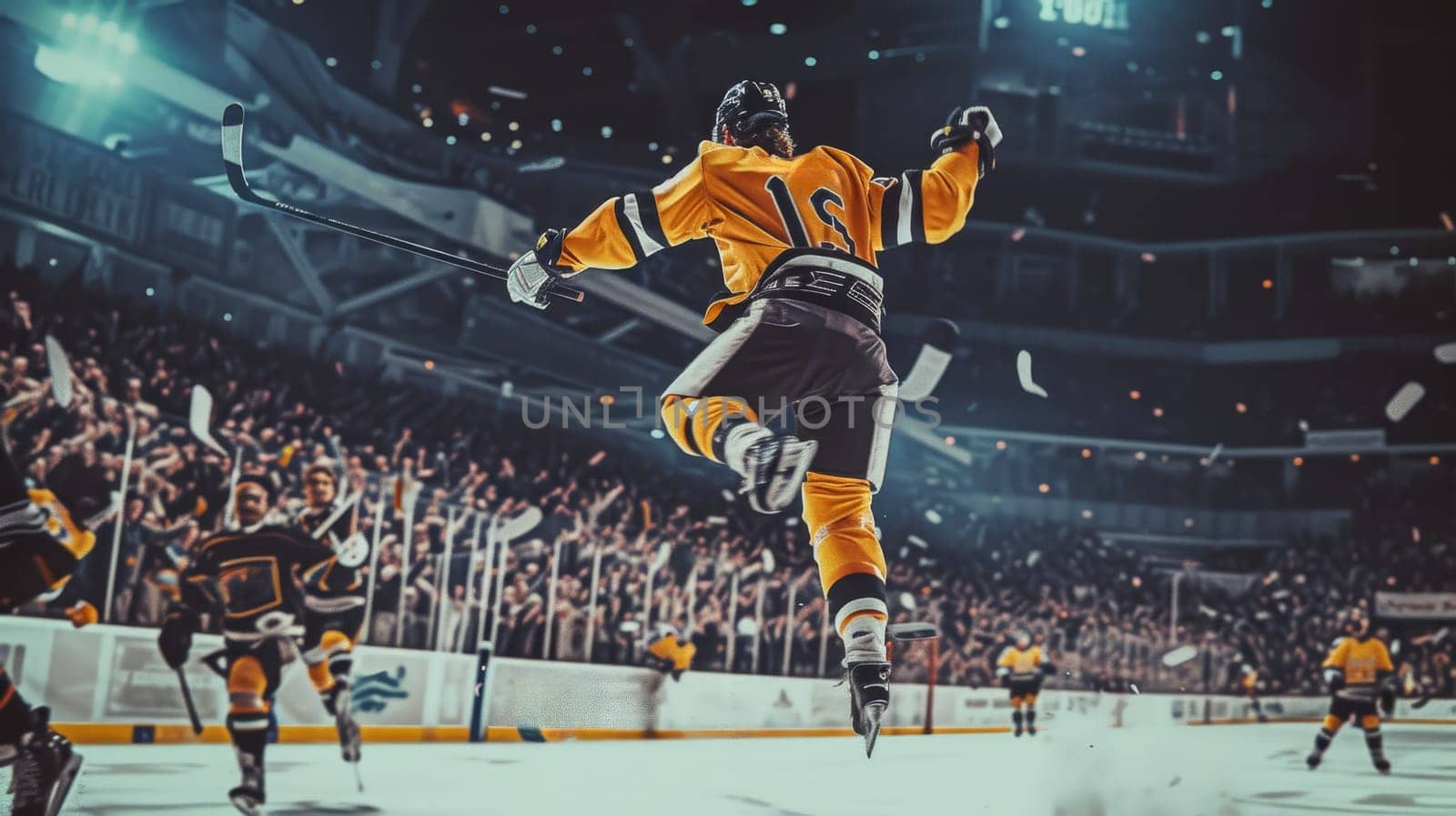 Hockey player in red celebrating a win with fists pumped in the air, illuminated by the spotlight