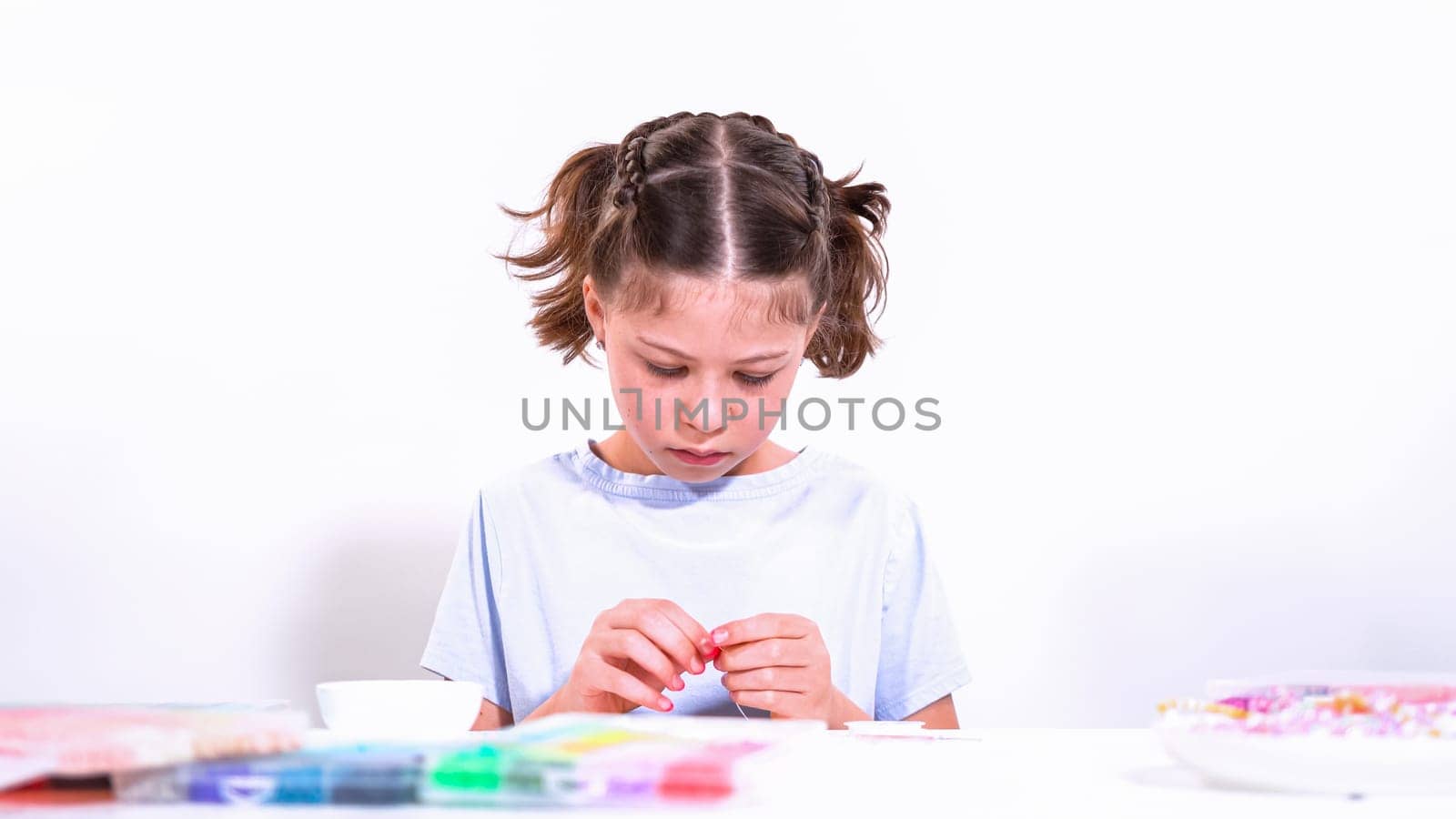 Little Girl Adventure in Bracelet Making with a Rainbow of Beads by arinahabich