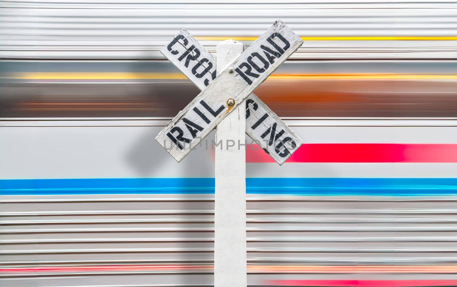 A High-Speed Train Moving Past A Wooden Railroad Crossing Sign In The USA, With Motion Blur