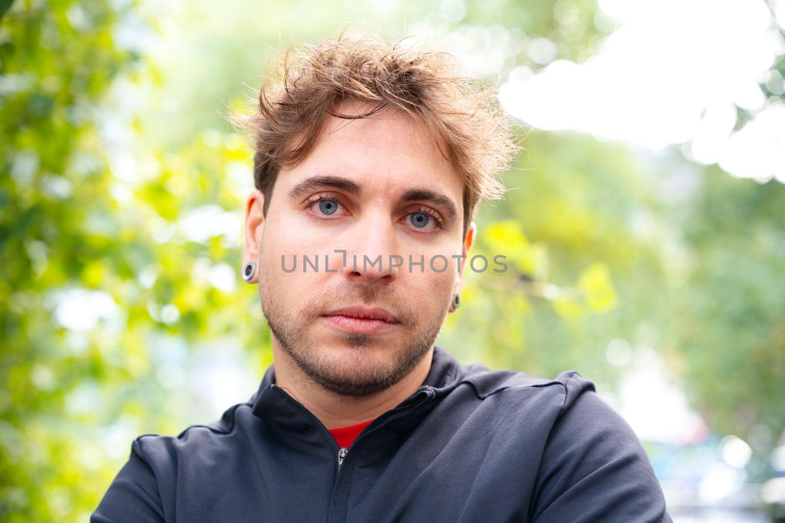 close-up serious sporty man looking at camera outdoors. by molesjuny