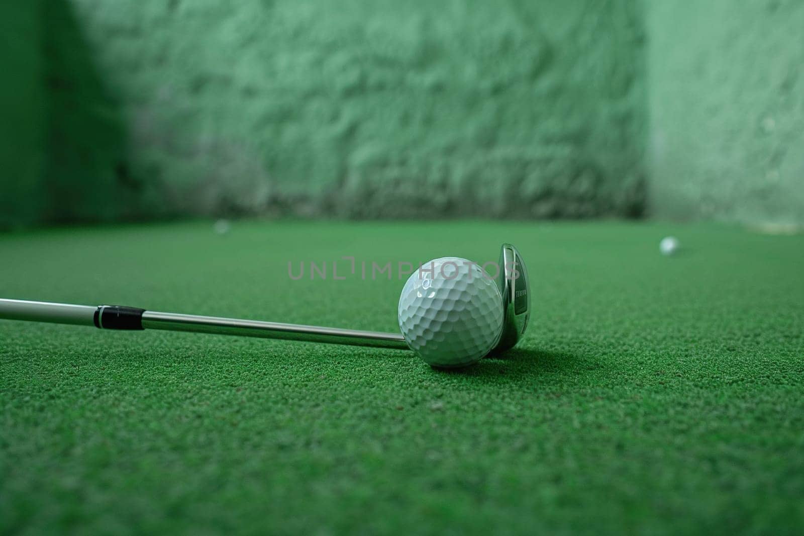 Close-up of a golf ball and club in the practice room. Generated by artificial intelligence by Vovmar