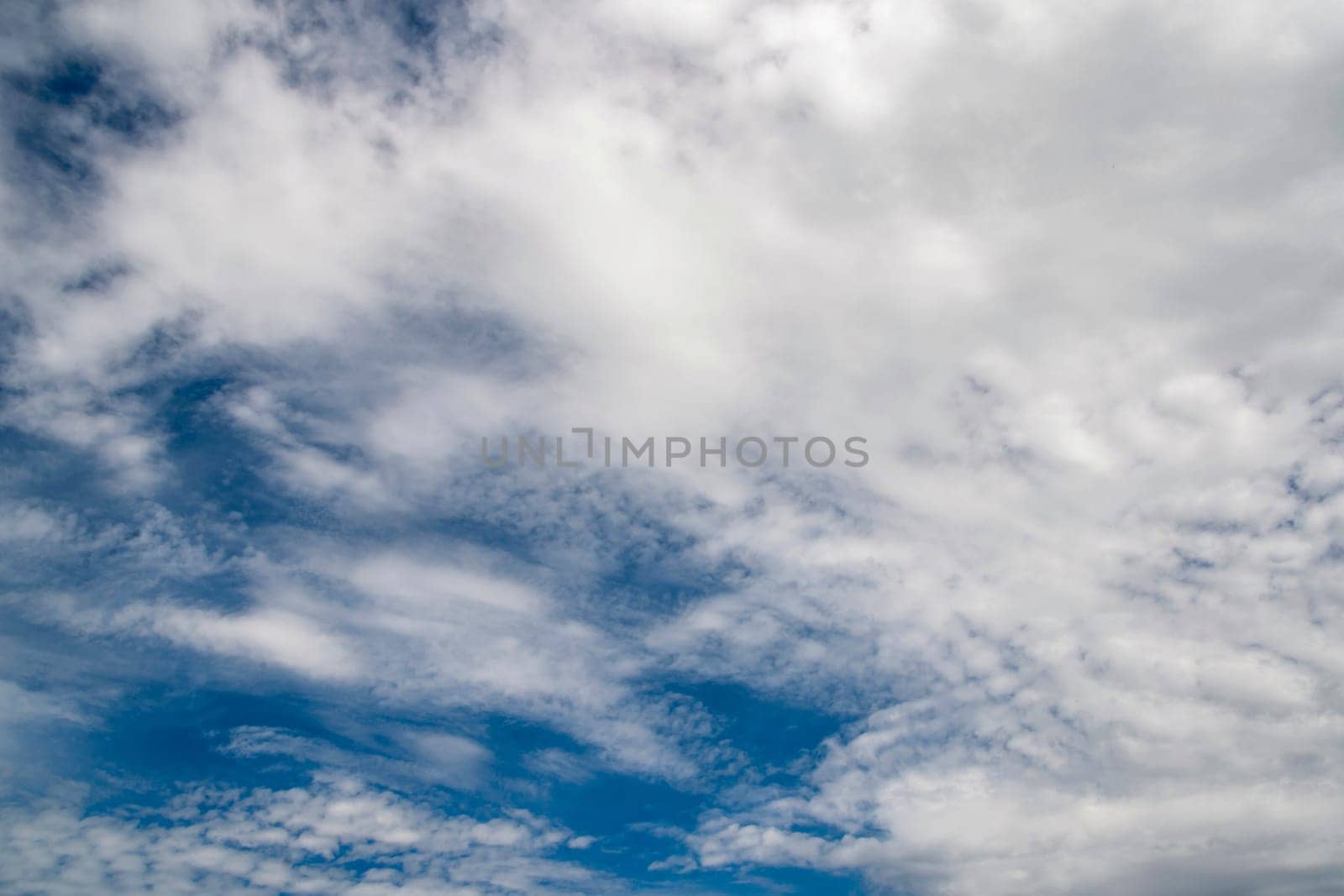 Sky is blue and cloudy. The clouds are white and fluffy by actionphoto50