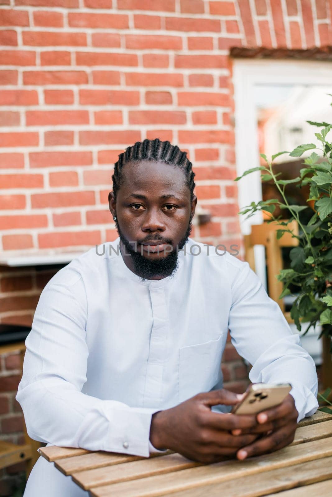 Banner portrait of a happy african american man smiling wearing ethnic dashiki clothes outdoor in summer street wall. Millennial generation student and youth. Copy space.