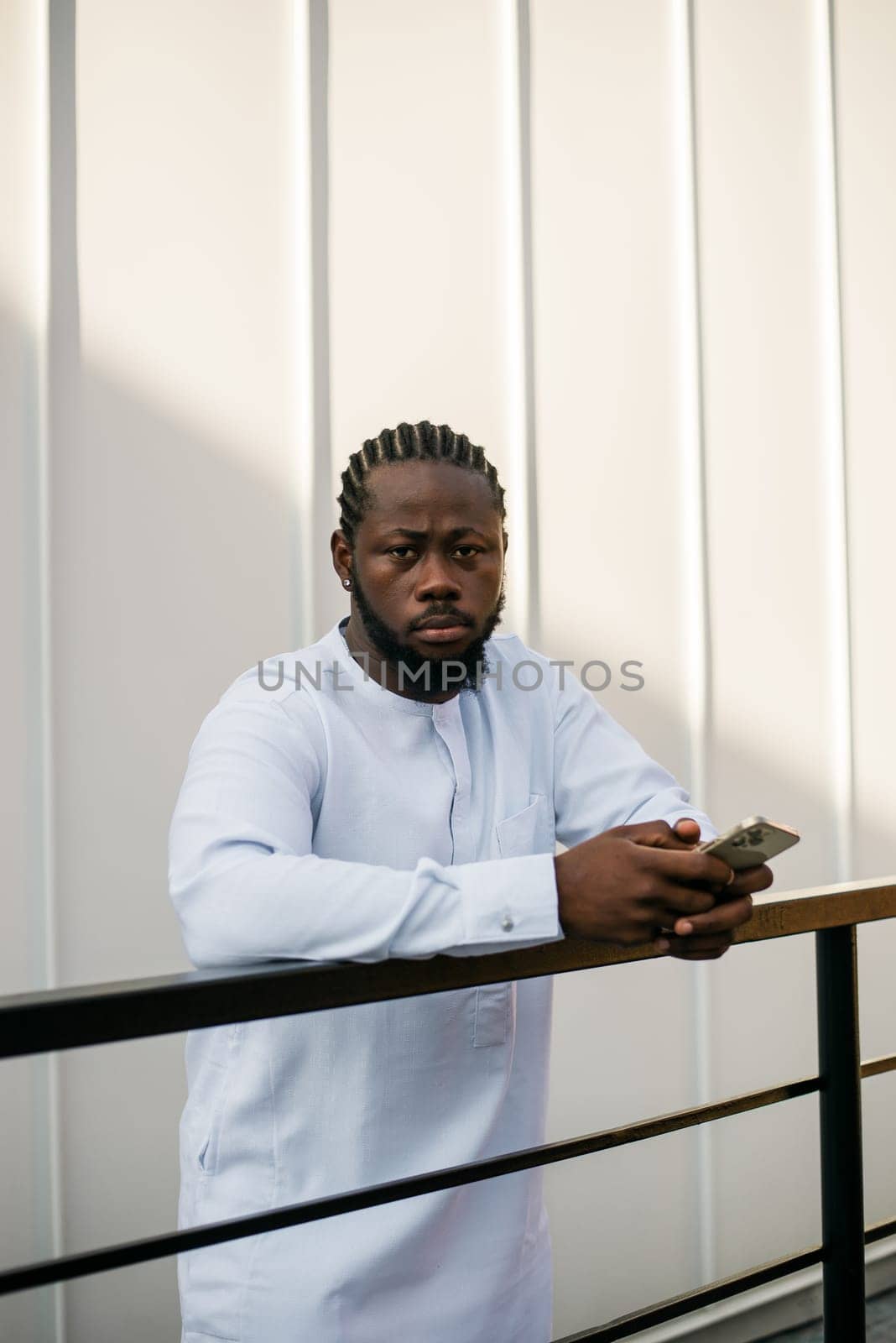 Banner portrait of a happy african american man smiling wearing ethnic dashiki clothes outdoor in summer street wall. Millennial generation student and youth. Copy space.