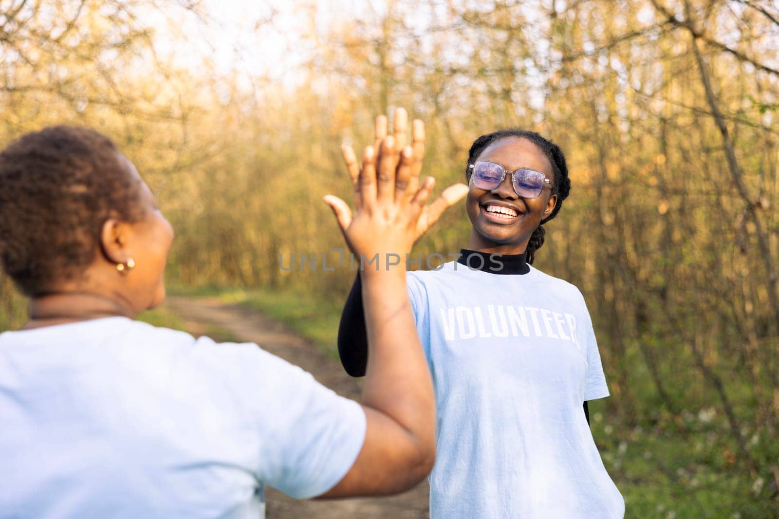 African american women sharing high five and being happy with the results by DCStudio