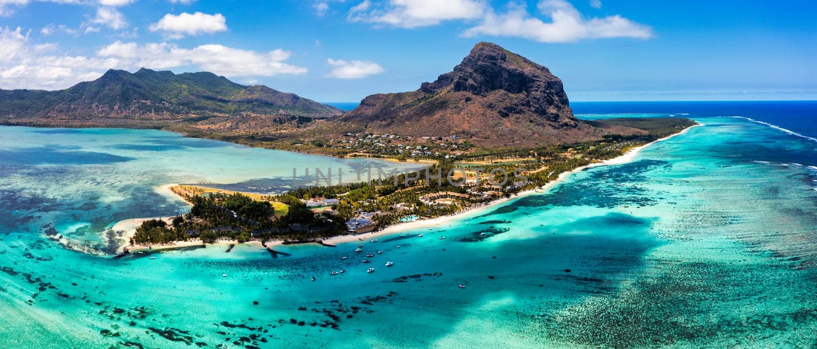 Aerial view of Le morne Brabant in Mauriutius. Tropical crystal ocean with Le Morne mountain and luxury beach in Mauritius. Le Morne beach with palm trees, white sand and luxury resorts, Mauritius.