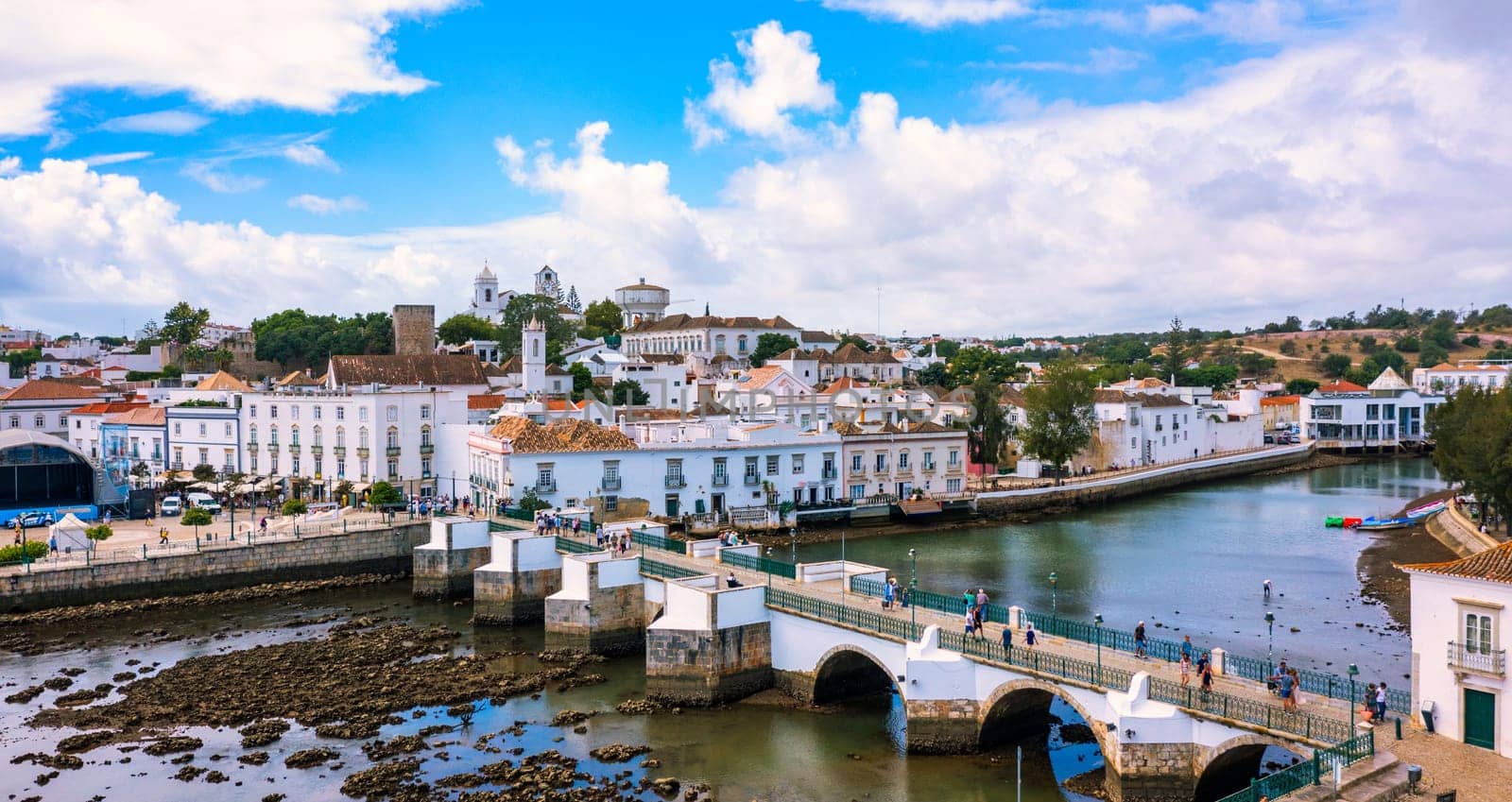 View on historic town of Tavira with Roman bridge over River Gilao, Algarve, Portugal. Cityscape of the Tavira old town with Clock tower, St Marys church, Algarve region, Portugal. 