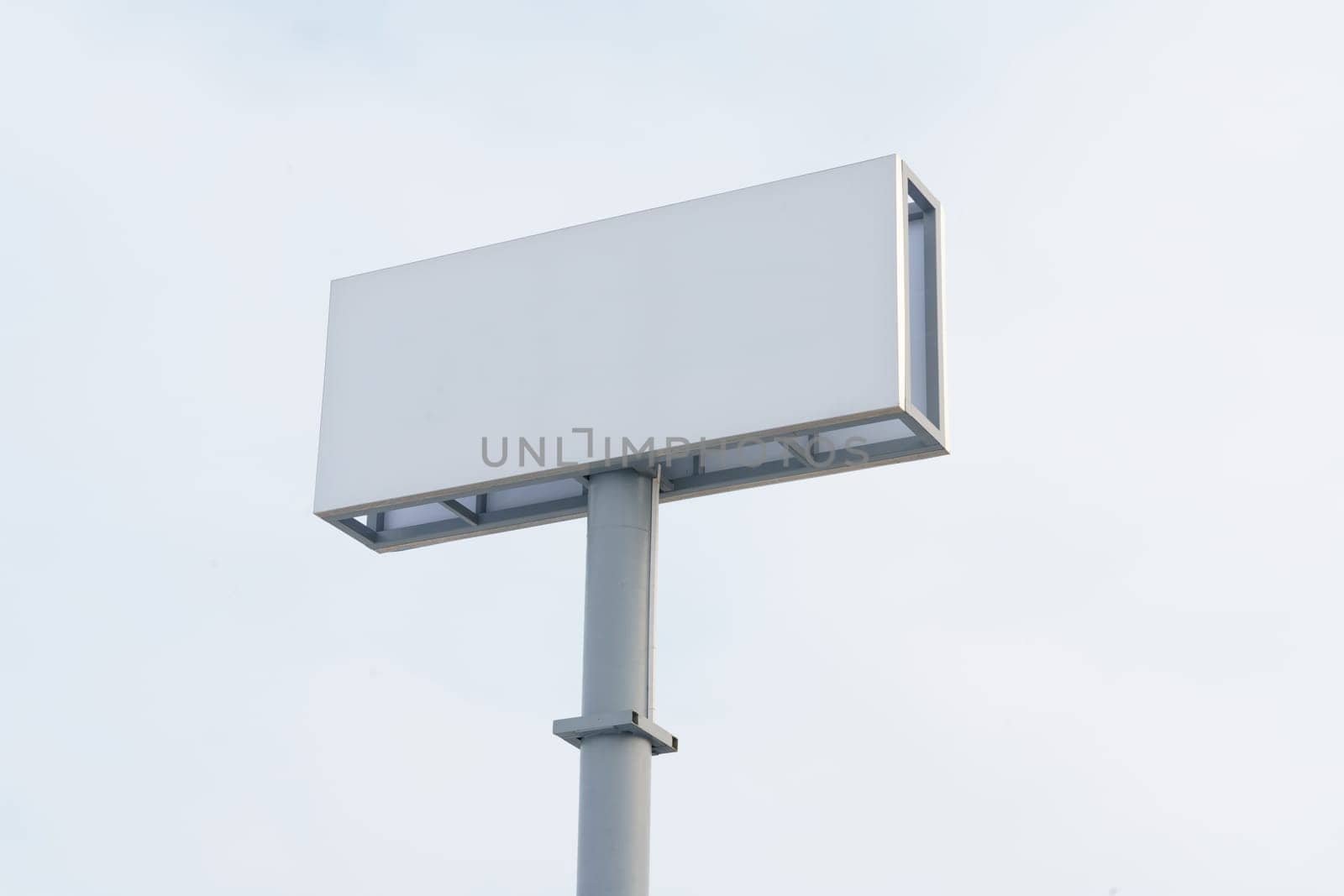 A large white sign stands on top of a metal pole against a white background, ready for display.