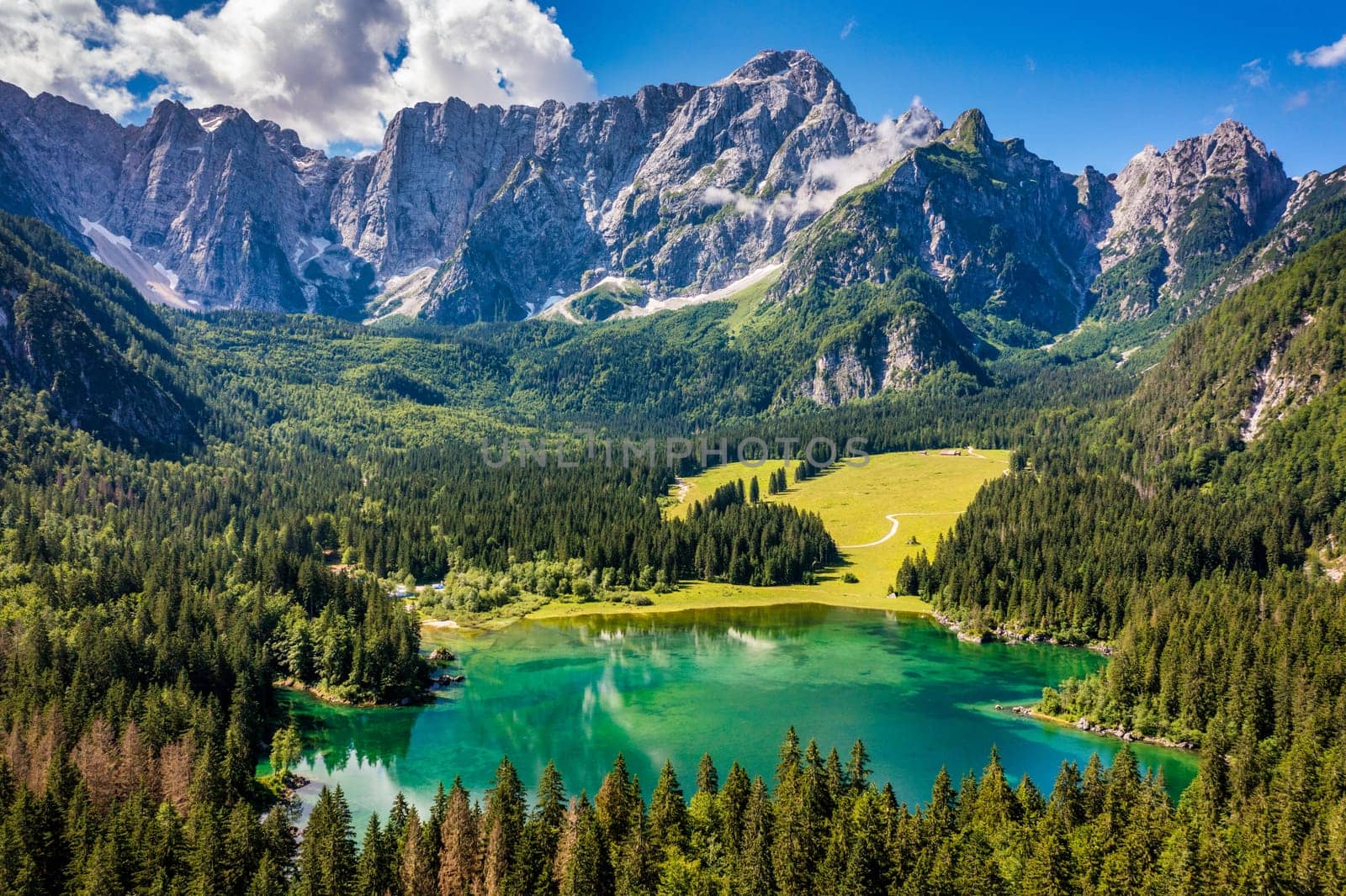 Lake of Fusine (Lago Superiore di Fusine) and the Mountain Range of Mount Mangart, Julian Alps, Tarvisio, Udine province, Friuli Venezia Giulia, Italy, Europe. Picturesque lake Lago Fusine in Italy.