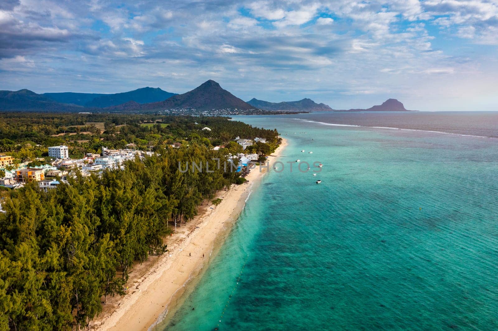 Beautiful Mauritius island with beach Flic en flac. Coral reef around tropical palm beach, Flic en Flac, Mauritius. Aerial view of a beautiful beach along the coast in Flic en Flac, Mauritius.
