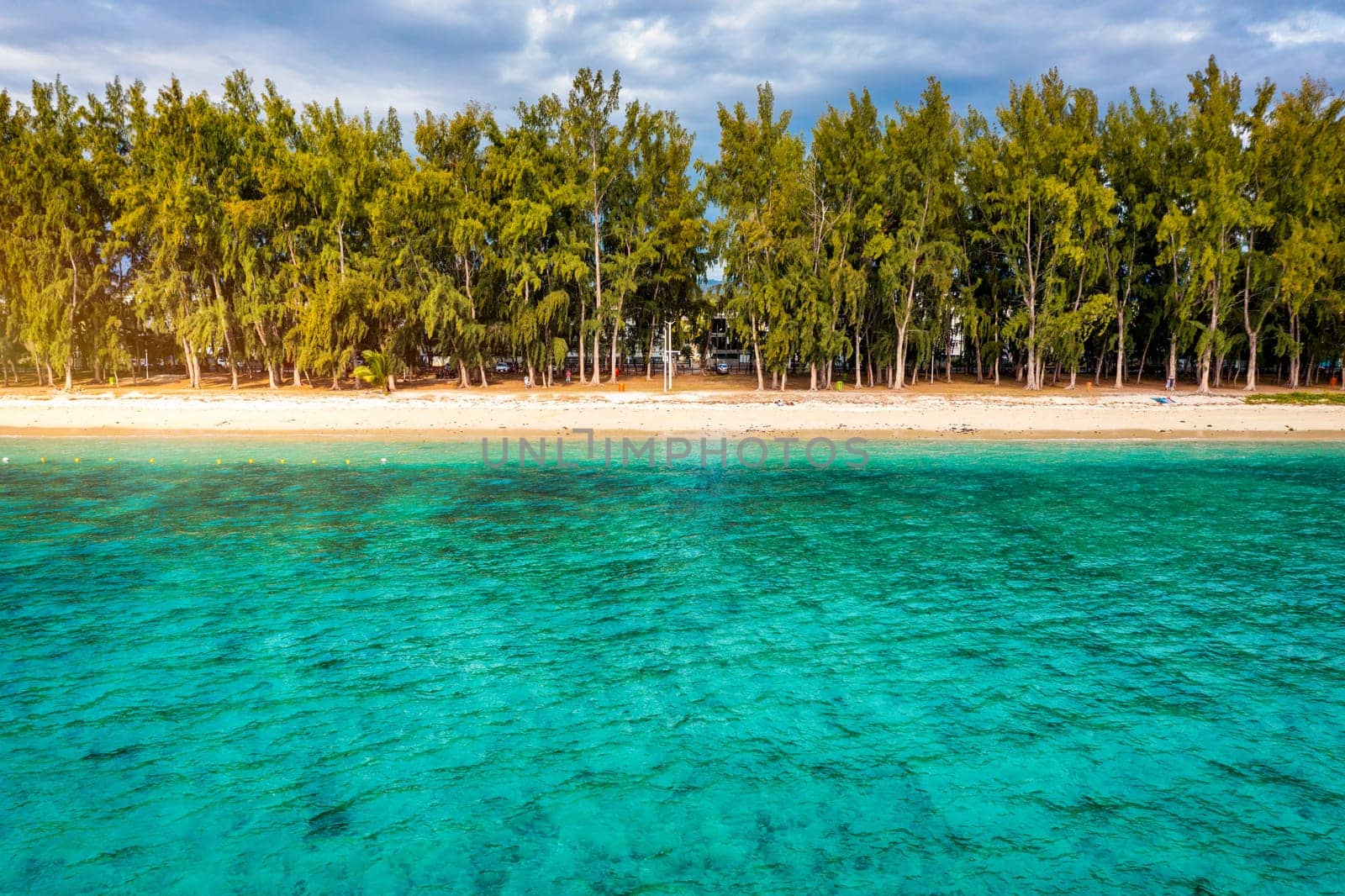 Beautiful Mauritius island with beach Flic en flac. Coral reef around tropical palm beach, Flic en Flac, Mauritius. Aerial view of a beautiful beach along the coast in Flic en Flac, Mauritius.