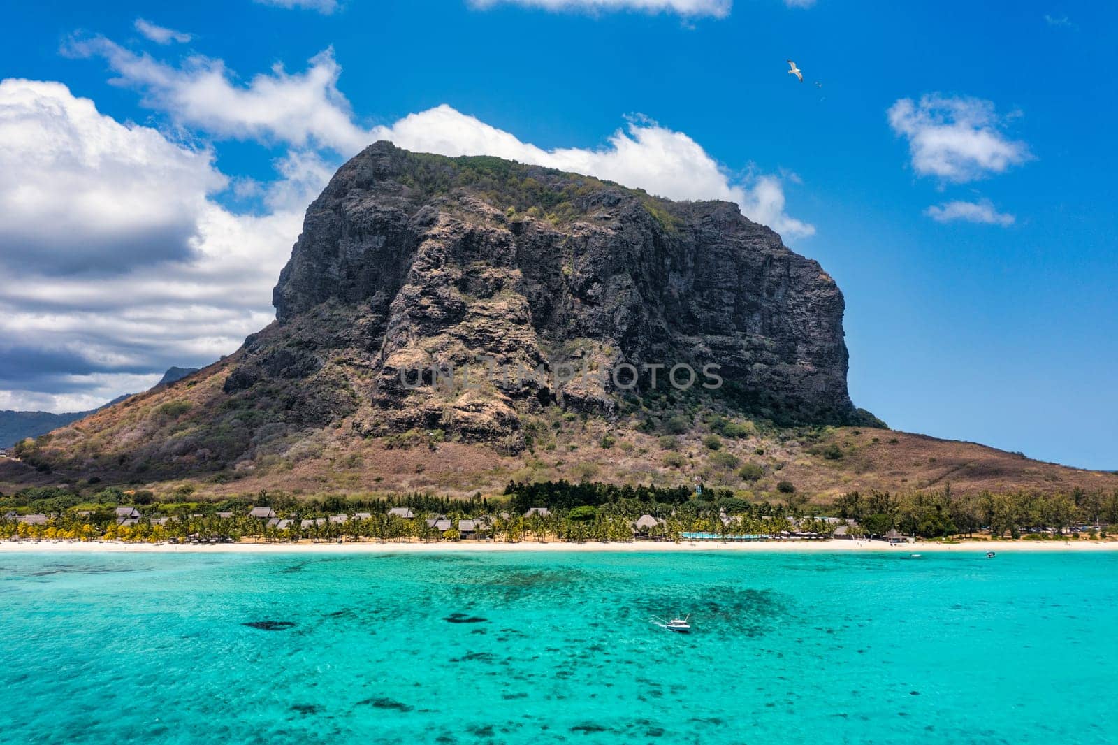 Aerial view of Le morne Brabant in Mauriutius. Tropical crystal ocean with Le Morne mountain and luxury beach in Mauritius. Le Morne beach with palm trees, white sand and luxury resorts, Mauritius.