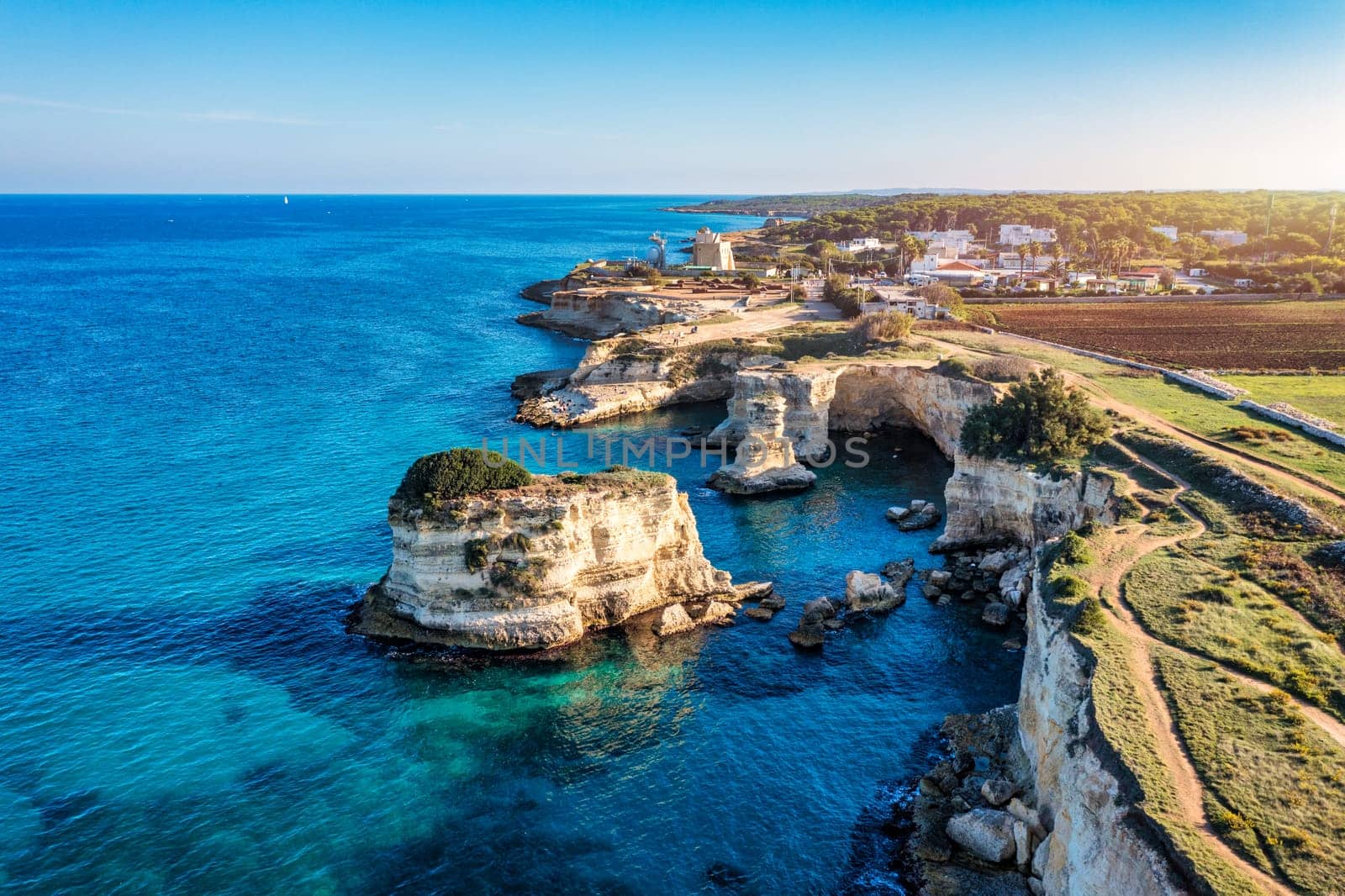 Stunning seascape with cliffs rocky arch and stacks (Faraglioni) at Torre Sant Andrea, Salento coast, Puglia region, Italy. Beautiful cliffs and sea stacks of Sant'Andrea, Salento, Apulia, Italy