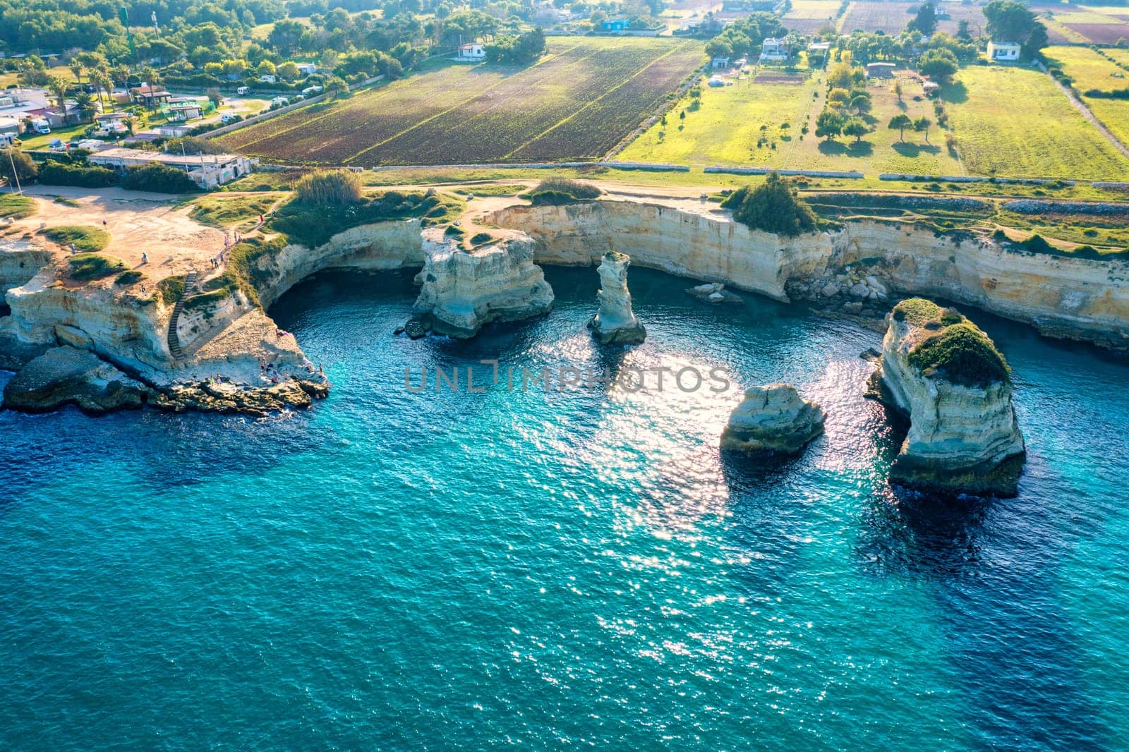 Stunning seascape with cliffs rocky arch and stacks (Faraglioni) at Torre Sant Andrea, Salento coast, Puglia region, Italy. Beautiful cliffs and sea stacks of Sant'Andrea, Salento, Apulia, Italy