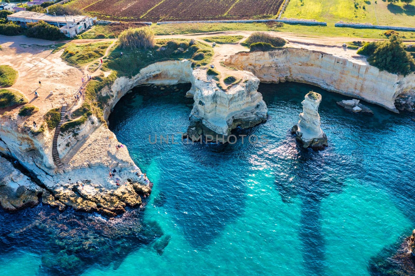 Stunning seascape with cliffs rocky arch and stacks (Faraglioni) at Torre Sant Andrea, Salento coast, Puglia region, Italy. Beautiful cliffs and sea stacks of Sant'Andrea, Salento, Apulia, Italy