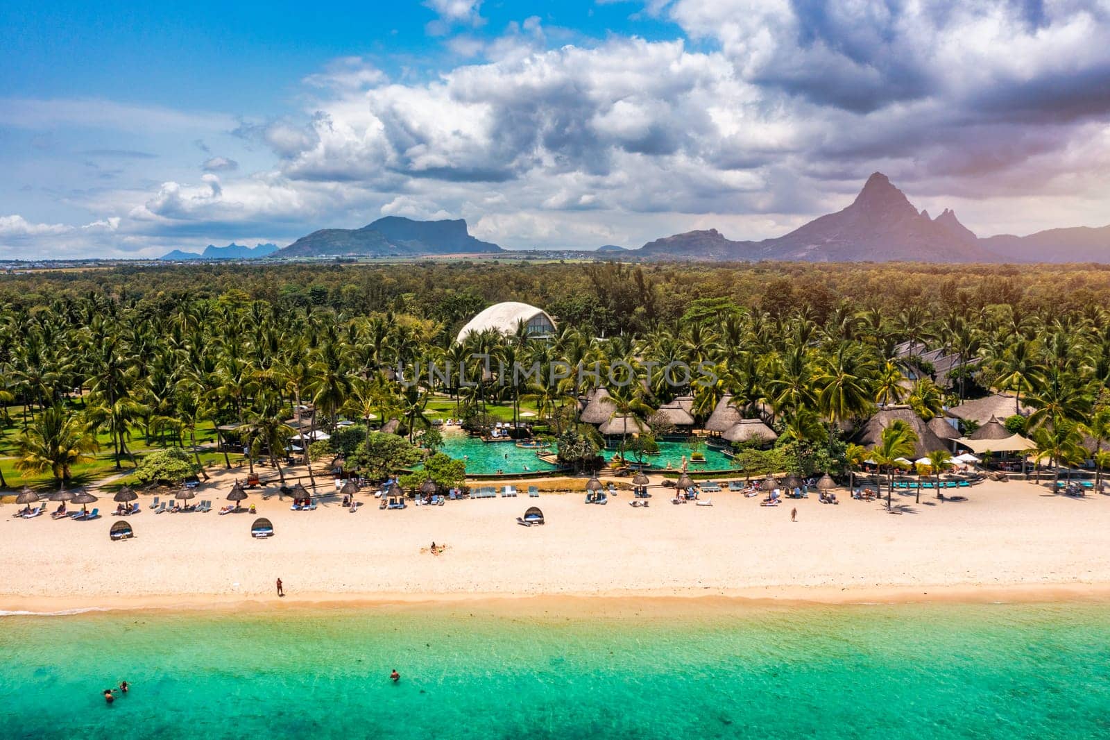 Beach of Flic en Flac with beautiful peaks in the background, Mauritius. Beautiful Mauritius Island with gorgeous beach Flic en Flac, aerial view from drone. Flic en Flac Beach, Mauritius Island.