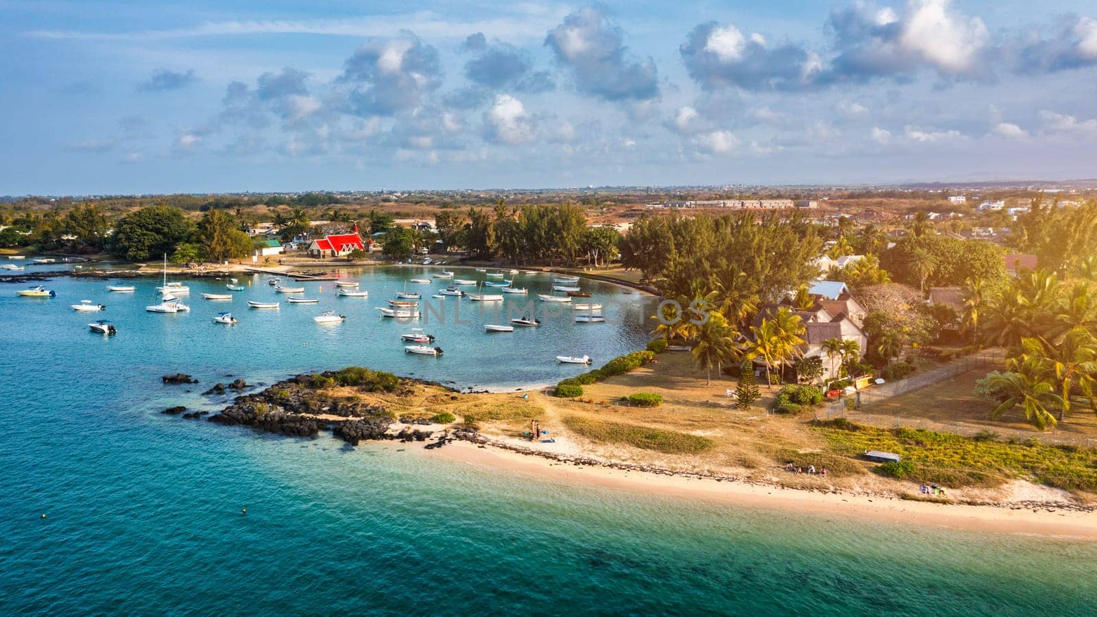 Cap Malheureux village, Mauritius Island. Notre Dame de Auxiliatrice, rural church with red roof in Cap Malheureux tropical village on Mauritius island, Indian Ocean.