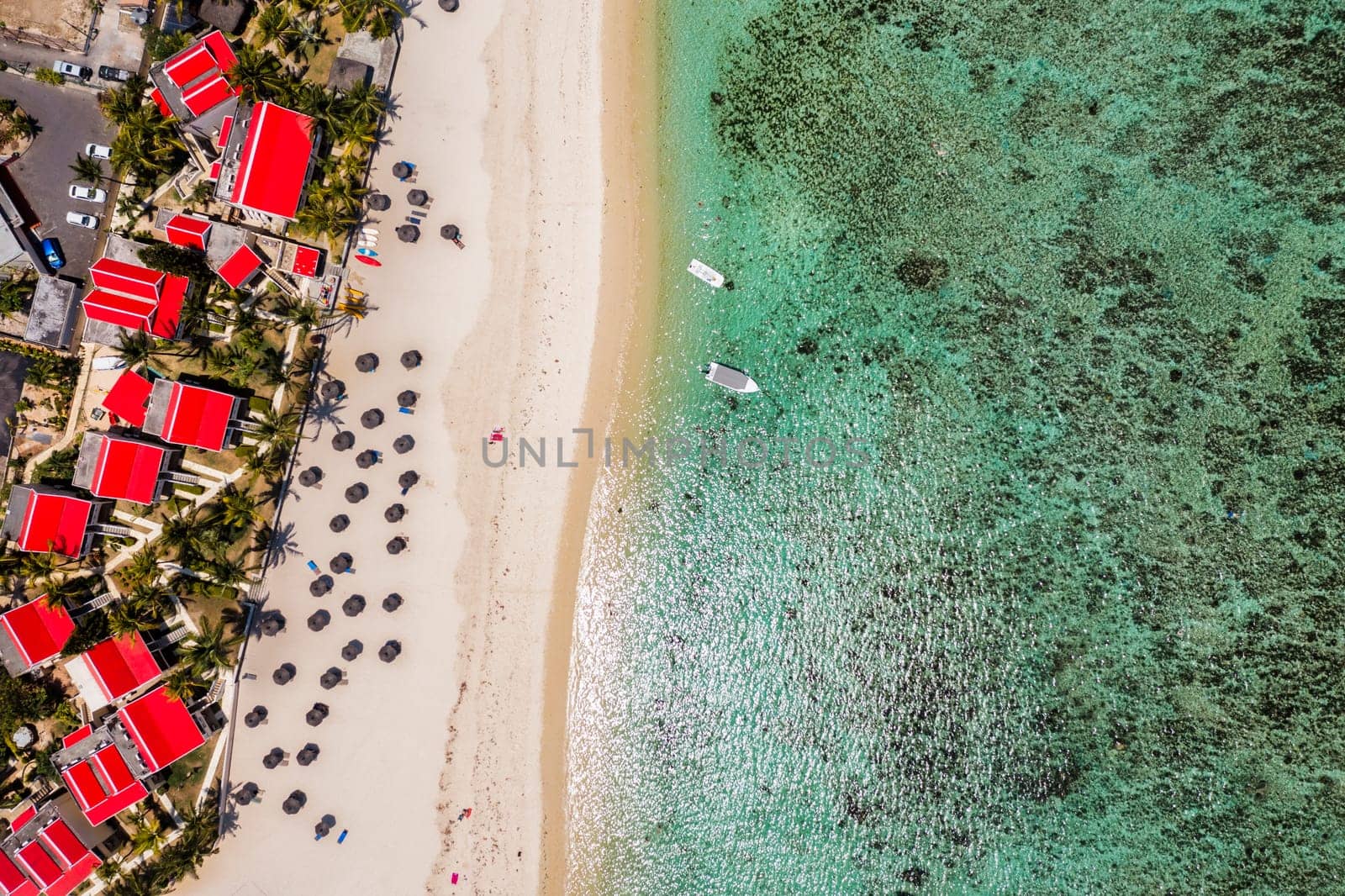 Beautiful Mauritius Island with gorgeous beach Flic en Flac, aerial view from drone. Mauritius, Black River, Flic-en-Flac view of oceanside village beach and luxurious hotel in summer.