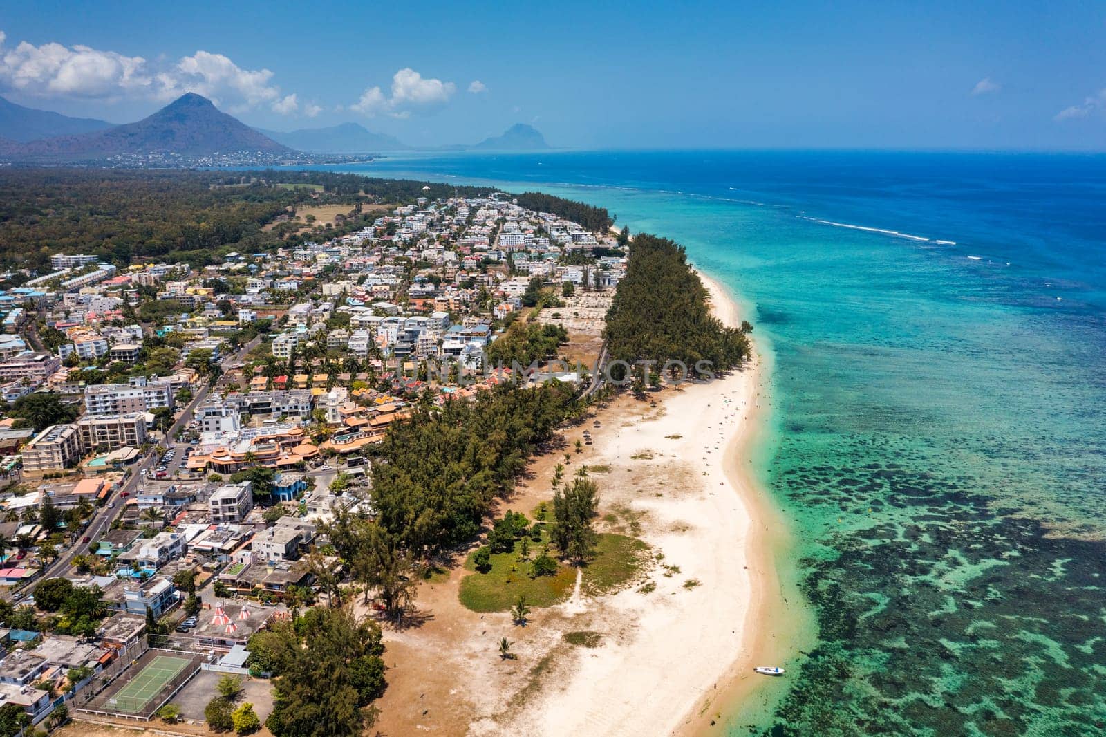 Beautiful Mauritius Island with gorgeous beach Flic en Flac, aerial view from drone. Mauritius, Black River, Flic-en-Flac view of oceanside village beach and luxurious hotel in summer. by DaLiu
