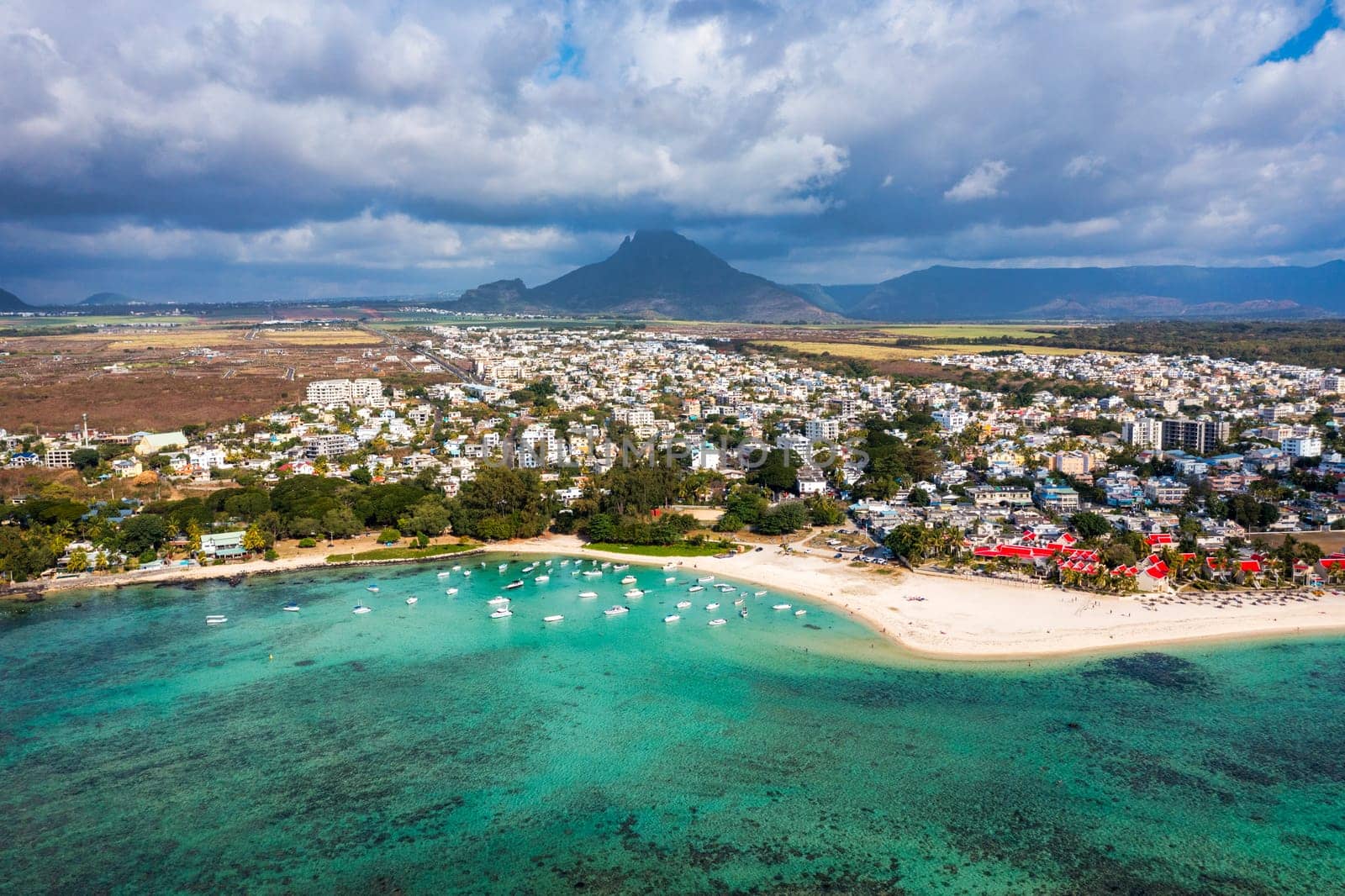 Beach of Flic en Flac with beautiful peaks in the background, Mauritius. Beautiful Mauritius Island with gorgeous beach Flic en Flac, aerial view from drone. Flic en Flac Beach, Mauritius Island.