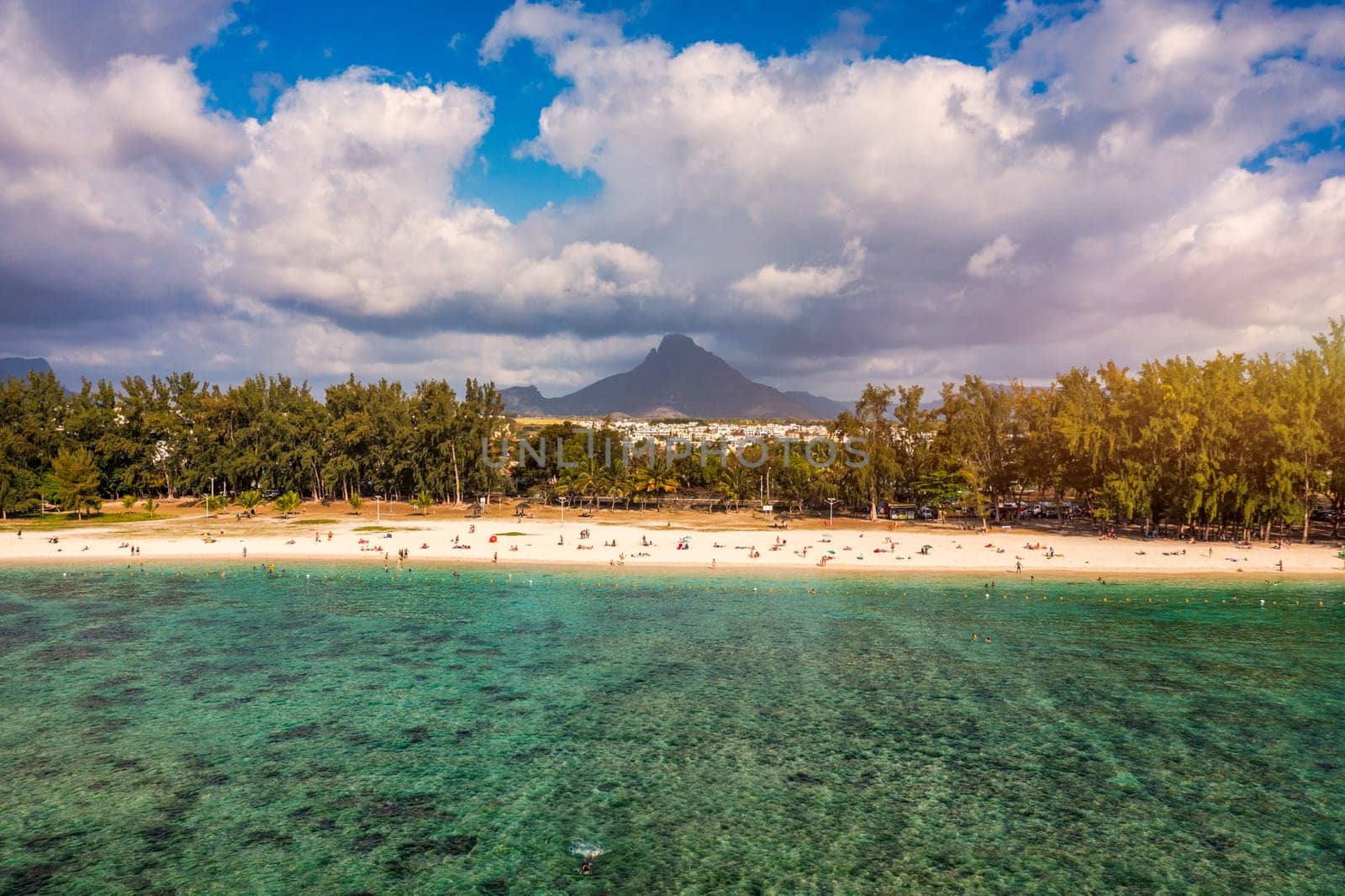 Beach of Flic en Flac with beautiful peaks in the background, Mauritius. Beautiful Mauritius Island with gorgeous beach Flic en Flac, aerial view from drone. Flic en Flac Beach, Mauritius Island.