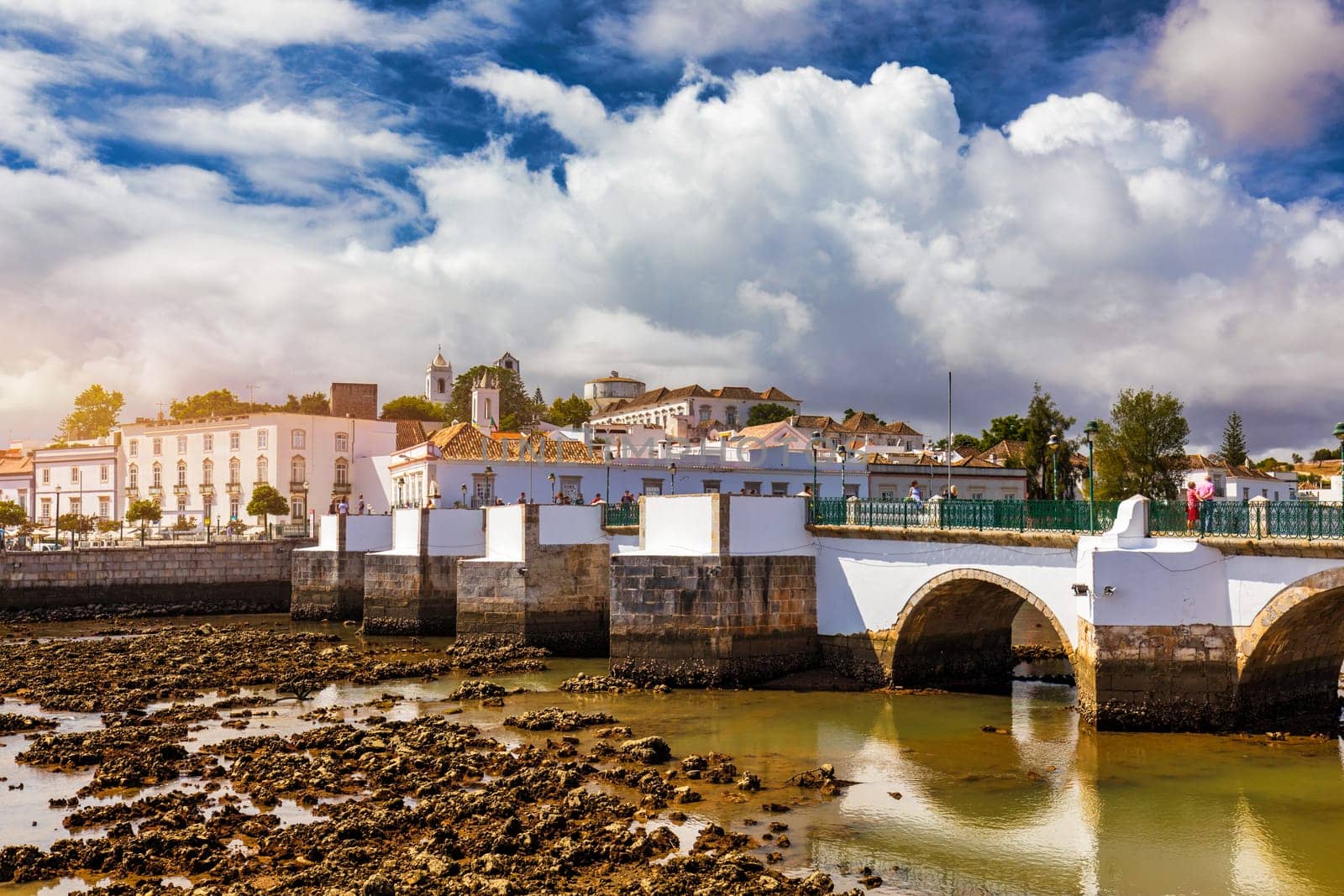 View of the city of Tavira, charming architecture of Tavira, Algarve, Portugal. Santiago of Tavira church in the old town of the beautiful city of Tavira in a sunny day. Algarve region, Portugal