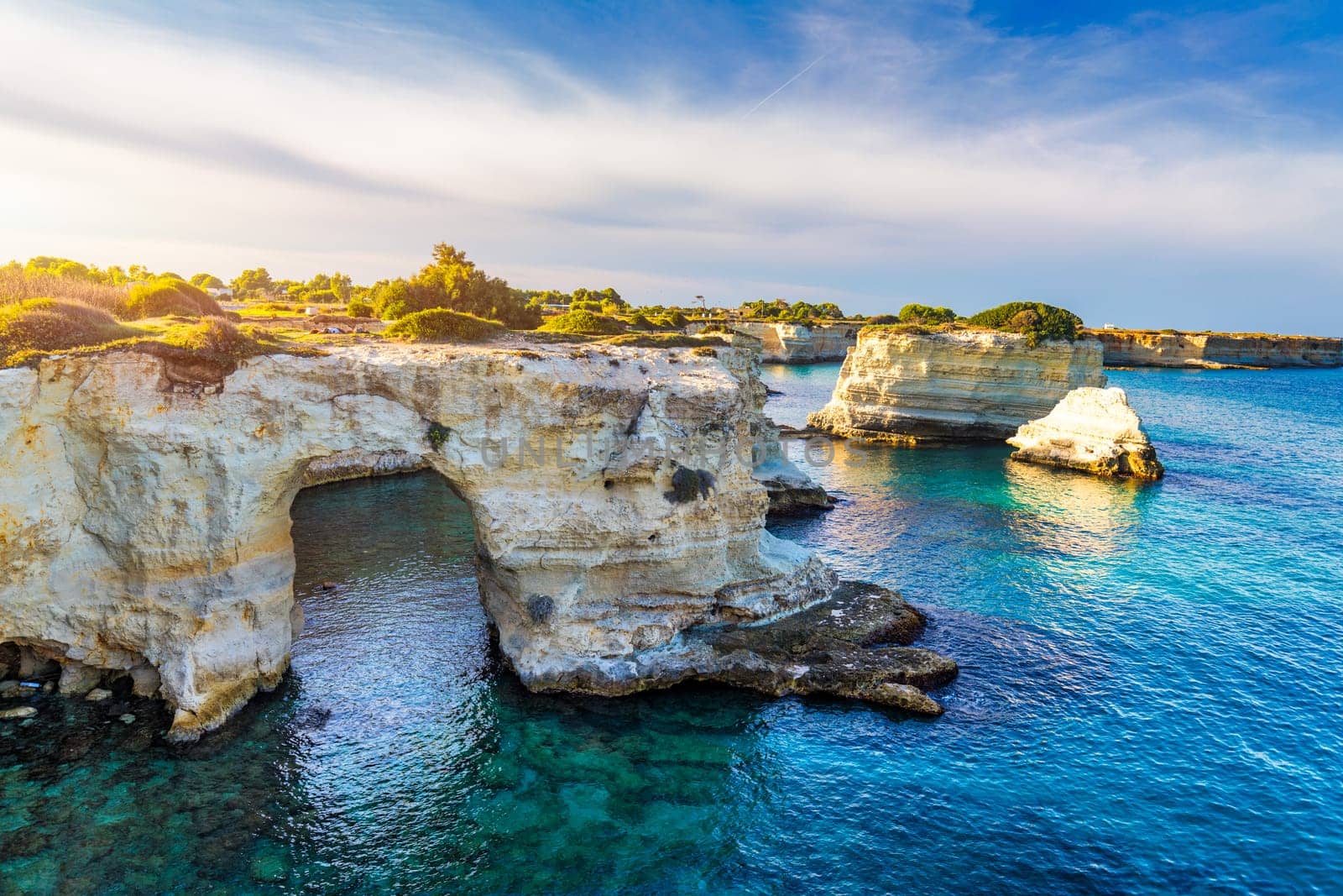 Stunning seascape with cliffs rocky arch and stacks (Faraglioni) at Torre Sant Andrea, Salento coast, Puglia region, Italy. Beautiful cliffs and sea stacks of Sant'Andrea, Salento, Apulia, Italy by DaLiu