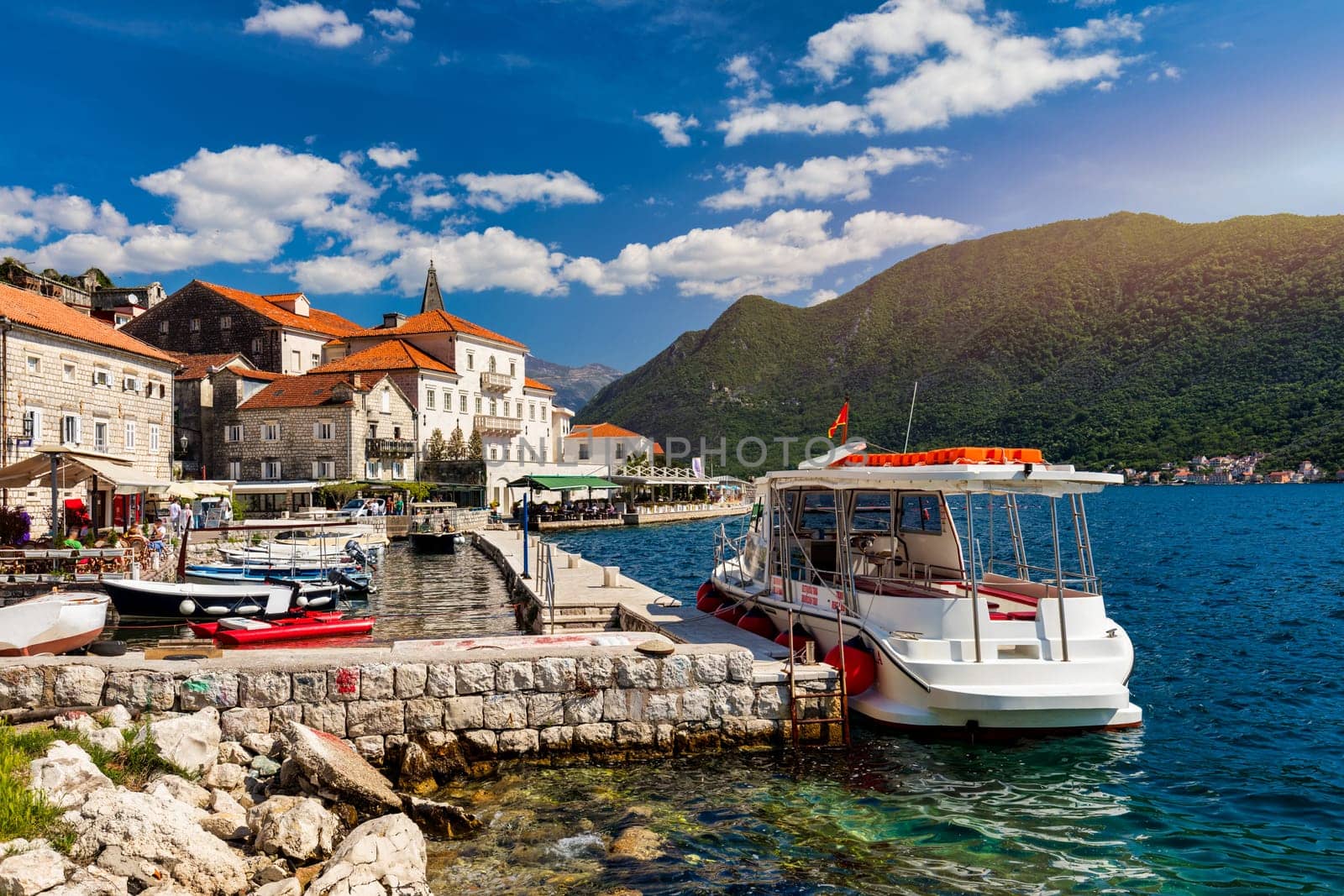 View of the historic town of Perast at famous Bay of Kotor on a beautiful sunny day with blue sky and clouds in summer, Montenegro. Historic city of Perast at Bay of Kotor in summer, Montenegro. by DaLiu