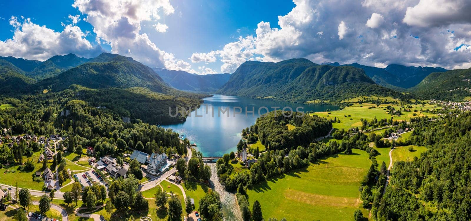 Aerial view of Bohinj lake in Julian Alps. Popular touristic destination in Slovenia. Bohinj Lake, Church of St John the Baptist. Triglav National Park, Julian Alps, Slovenia. 