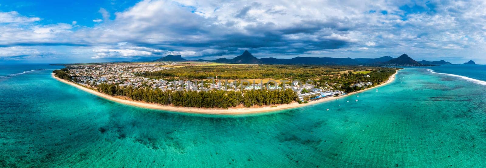 Beach of Flic en Flac with beautiful peaks in the background, Mauritius. Beautiful Mauritius Island with gorgeous beach Flic en Flac, aerial view from drone. Flic en Flac Beach, Mauritius Island. by DaLiu