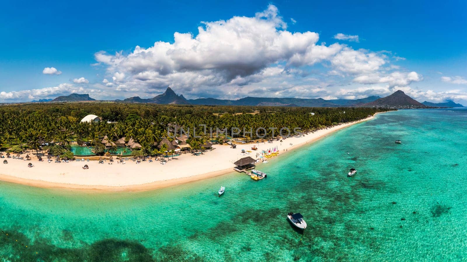 Beautiful Mauritius Island with gorgeous beach Flic en Flac, aerial view from drone. Mauritius, Black River, Flic-en-Flac view of oceanside village beach and luxurious hotel in summer.