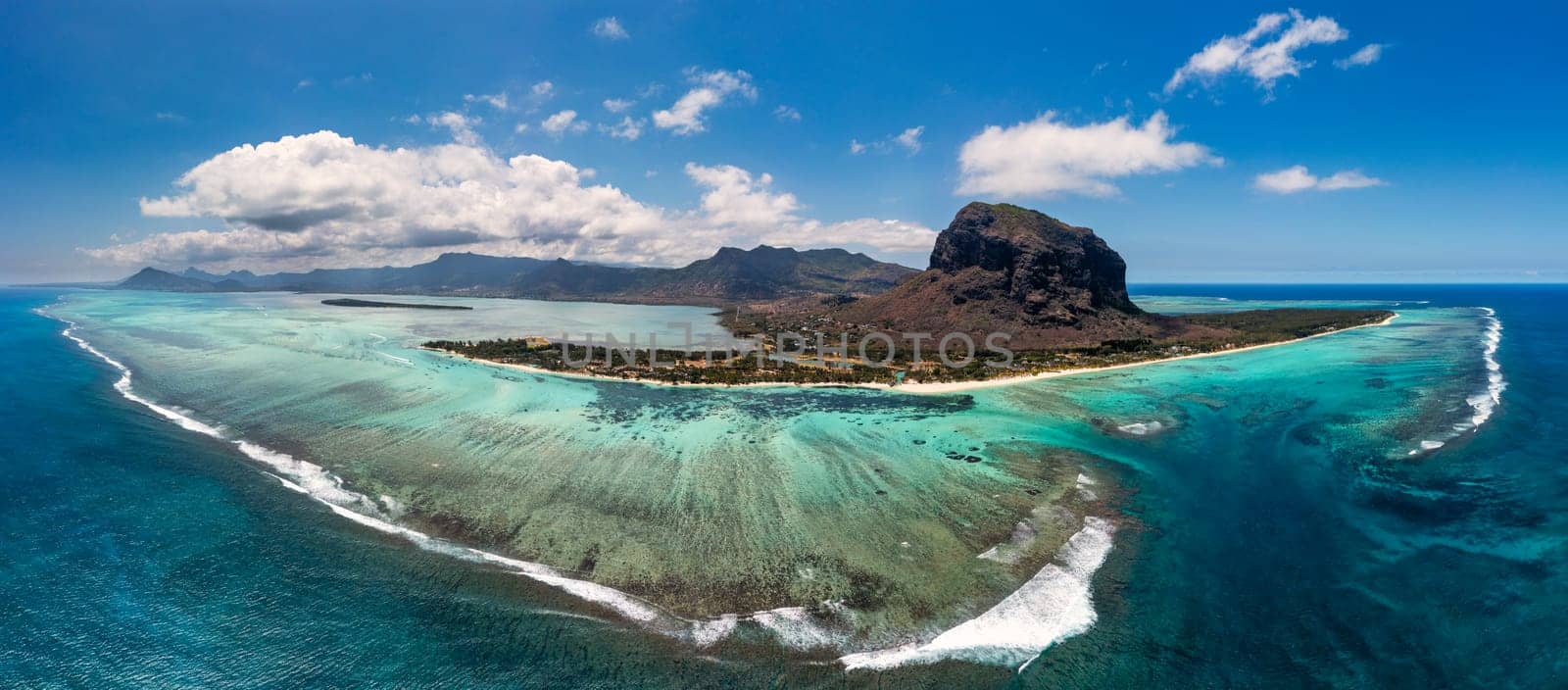 Aerial view of Le morne Brabant in Mauriutius. Tropical crystal ocean with Le Morne mountain and luxury beach in Mauritius. Le Morne beach with palm trees, white sand and luxury resorts, Mauritius.