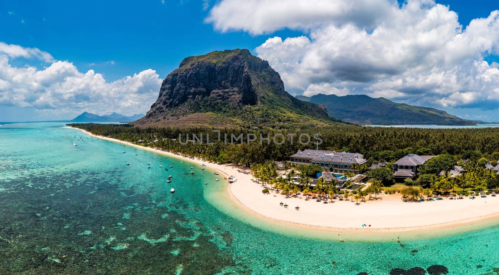 Aerial view of Le morne Brabant in Mauriutius. Tropical crystal ocean with Le Morne mountain and luxury beach in Mauritius. Le Morne beach with palm trees, white sand and luxury resorts, Mauritius.