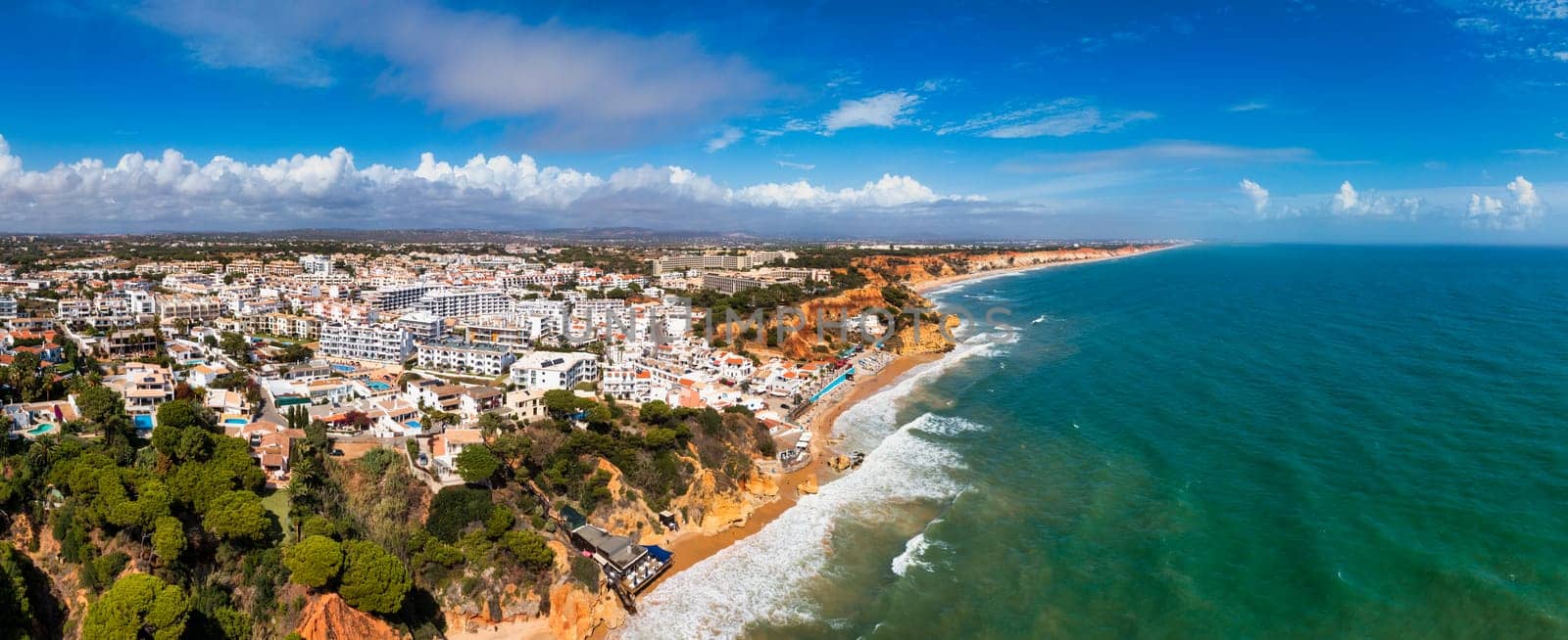 Amazing view from the sky of town Olhos de Agua in Albufeira, Algarve, Portugal. Aerial coastal view of town Olhos de Agua, Albufeira area, Algarve, Portugal.