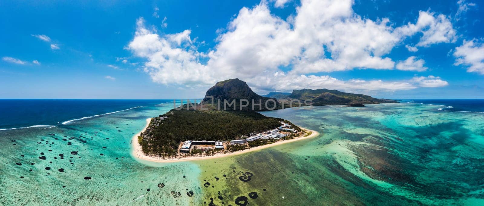 Aerial view of Le morne Brabant in Mauriutius. Tropical crystal ocean with Le Morne mountain and luxury beach in Mauritius. Le Morne beach with palm trees, white sand and luxury resorts, Mauritius.