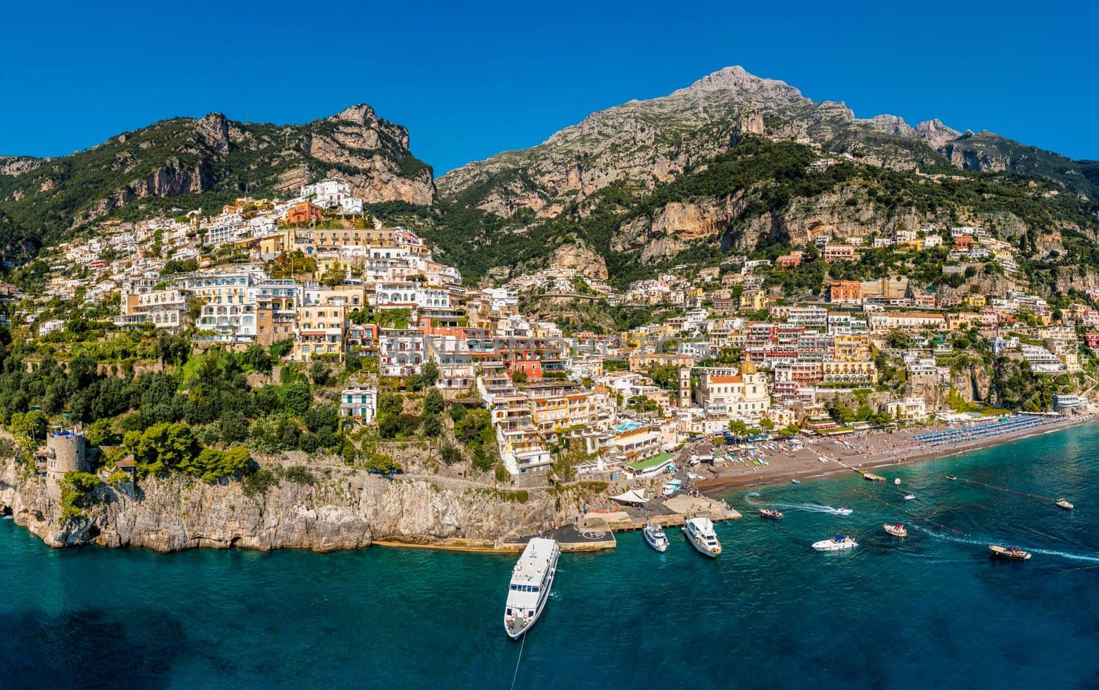 Aerial view of Positano with comfortable beach and blue sea on Amalfi Coast in Campania, Italy. Positano village on the Amalfi Coast, Salerno, Campania. Beautiful Positano, Amalfi Coast in Campania.