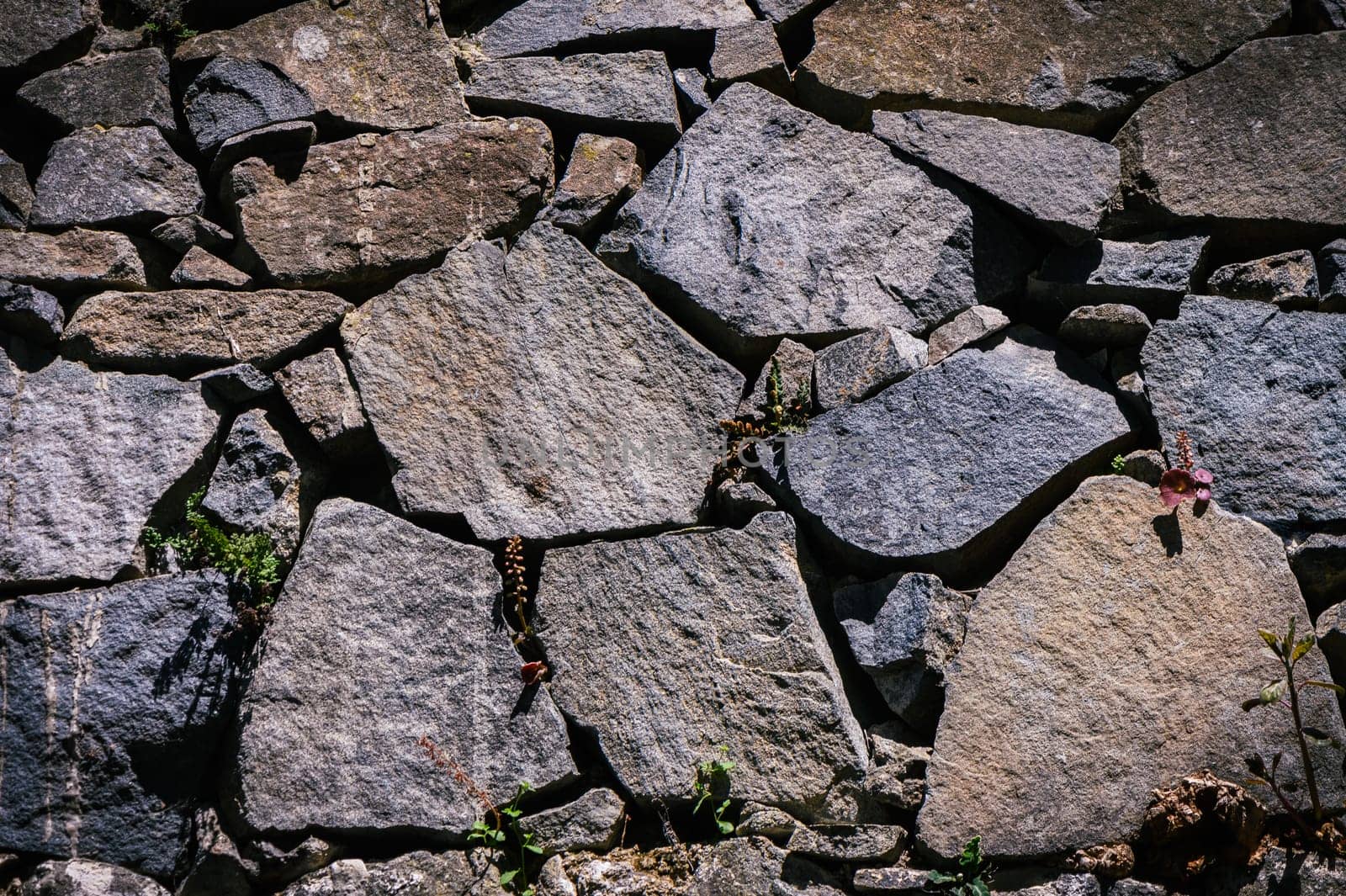 Full frame of a facade of a wall of stone constructed with volcanic rocks of origin 2