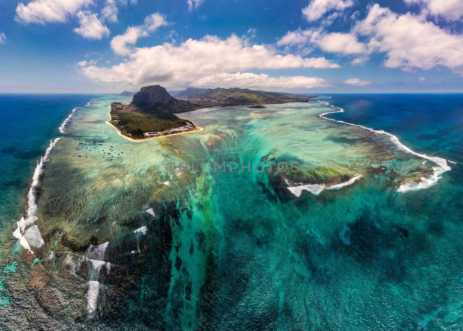 Aerial view of Mauritius island panorama and famous Le Morne Brabant mountain, beautiful blue lagoon and underwater waterfall. Le Morne Brabant peninsula and Underwater Waterfall, Mauritius.