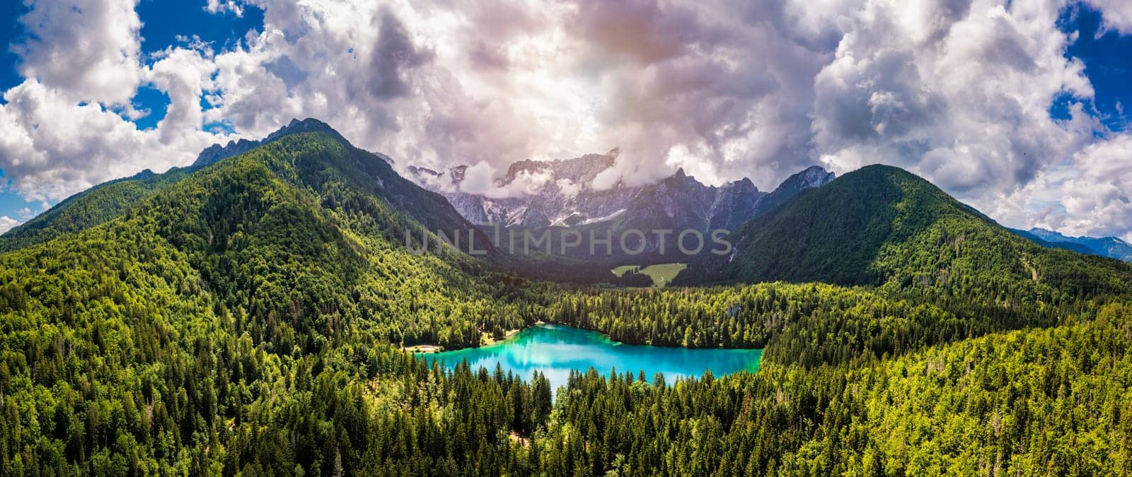 Picturesque lake Lago Fusine in Italy. Fusine lake with Mangart peak on background. Popular travel destination of Julian Alps. Location: Tarvisio comune , Province of Udine, Italy, Europe.