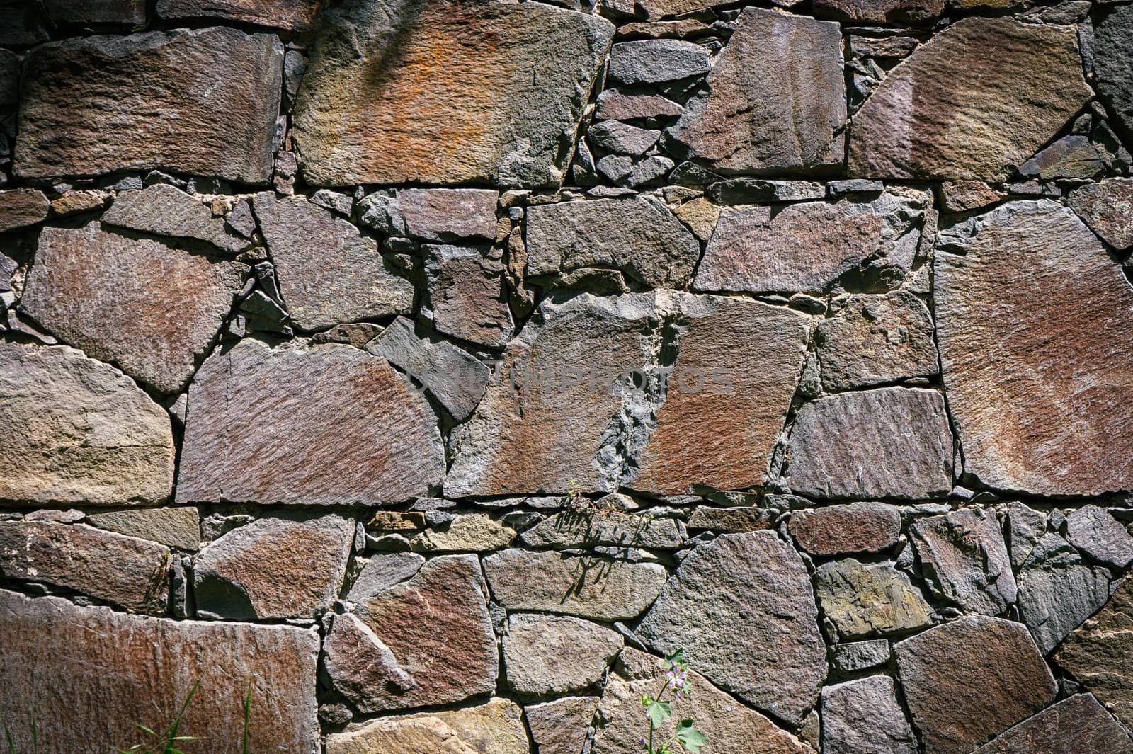 Full frame of a facade of a wall of stone constructed with volcanic rocks of origin