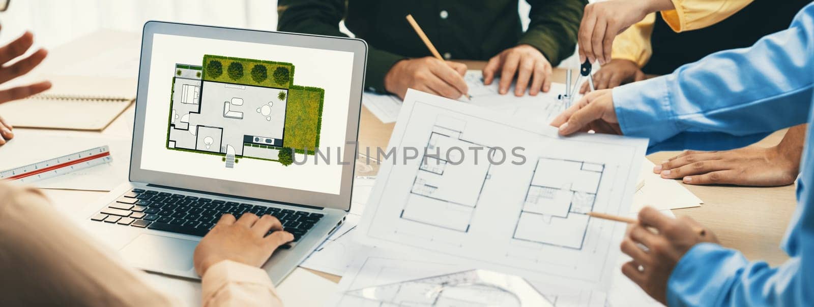 Professional architect decide the blueprint for eco-friendly house during discussion about changing blueprint plan at meeting table with architectural document scatter around. Closeup. Delineation