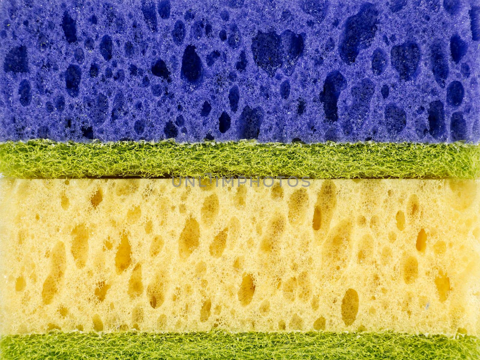 Close up of horizontally stacked sponges in blue, yellow colors by NetPix