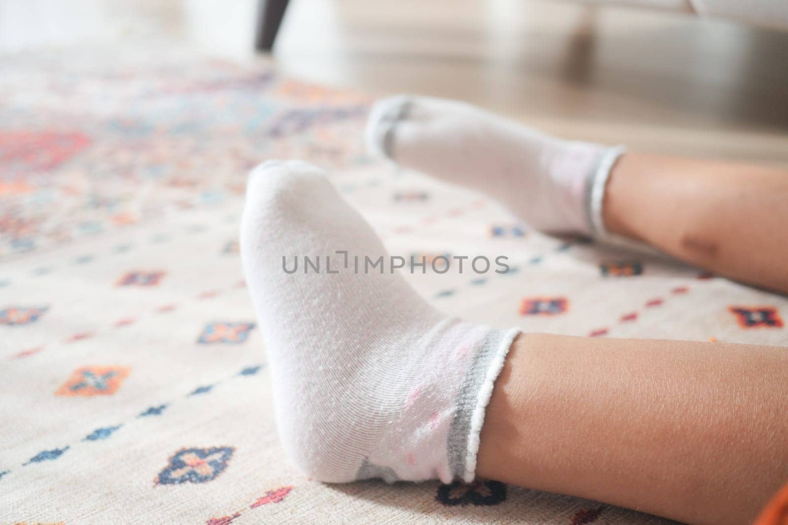a white soft socks on child feet . by towfiq007