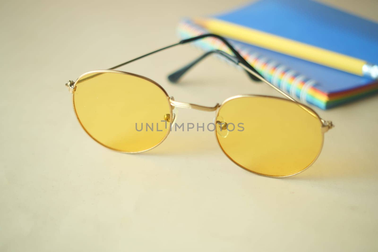 close up of eyeglass and newspaper on table