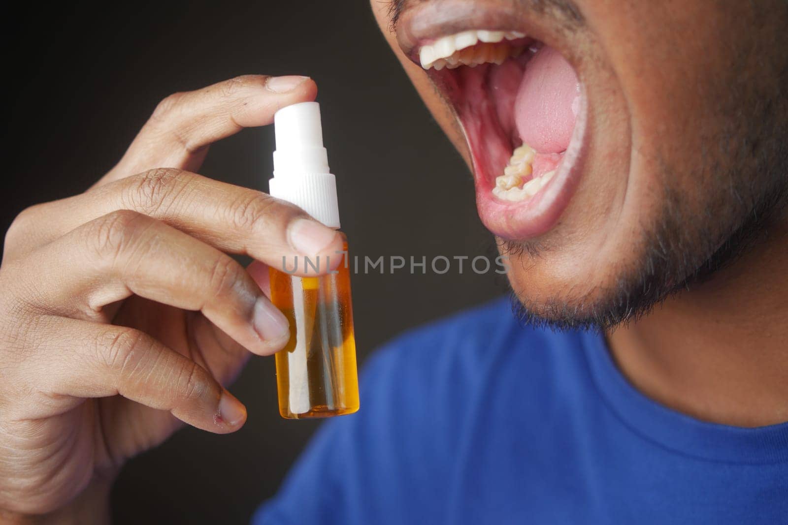 Man Applying Fresh Breath Spray