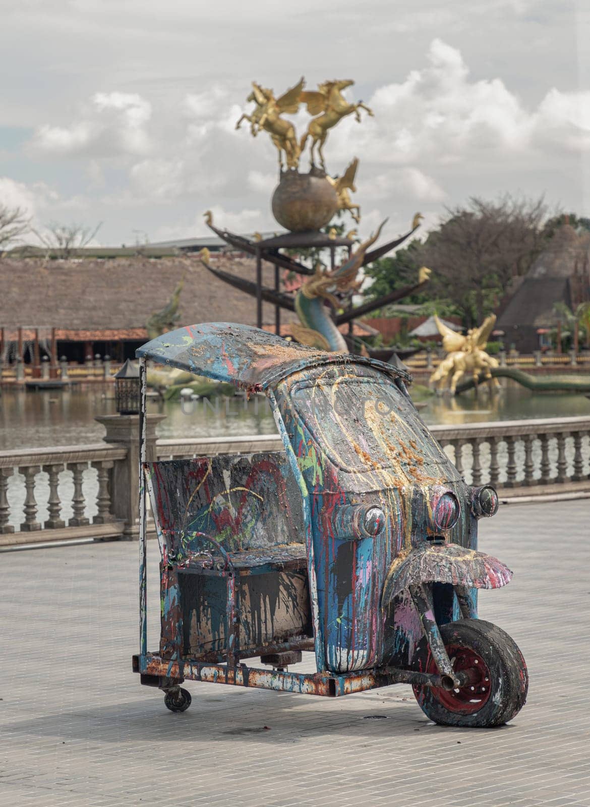 Bangkok, Thailand - 16 Jun, 2023 - Oil and Acrylic Painted art design on Tuk-Tuk vehicle cut in half (Thailand Car Scooter) parked on the street. Colorful with Thai Street Art, Space for text, Selective focus.
