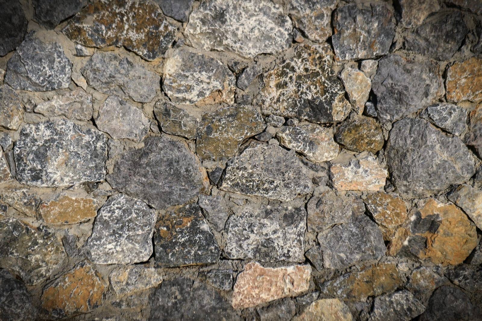 grey stone dark wall of medieval horizontal stones facade background by Mixa74