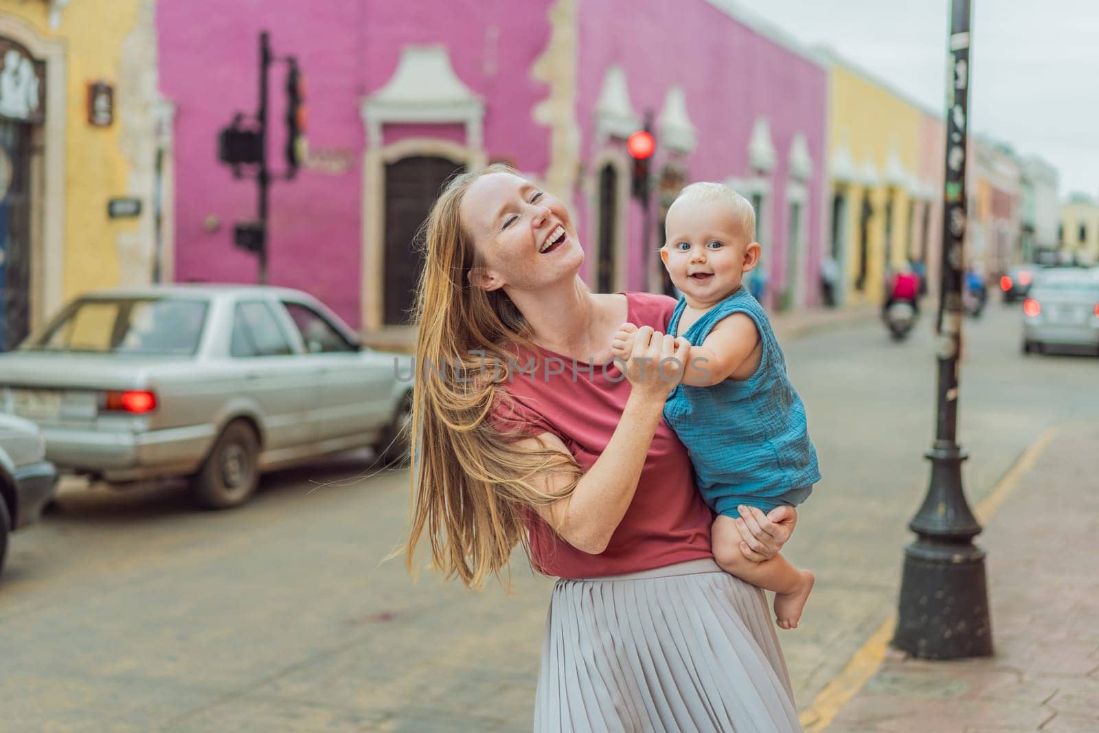 Mother and baby son tourists explore the vibrant streets of Valladolid, Mexico, immersing herself in the rich culture and colorful architecture of this charming colonial town by galitskaya